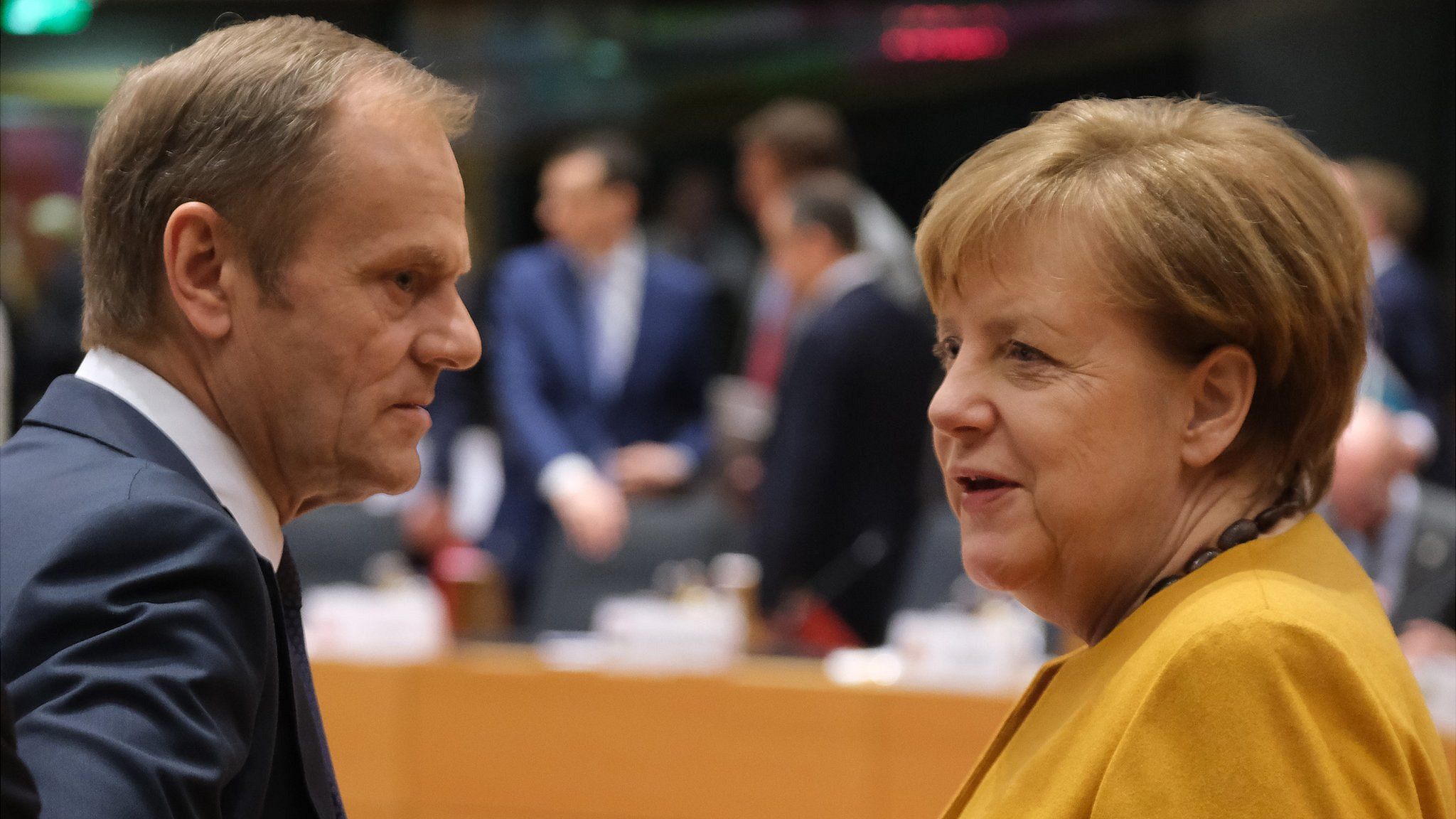 German Chancellor Angela Merkel speaks with European Council President Donald Tusk on the second day of an EU summit on March 22,