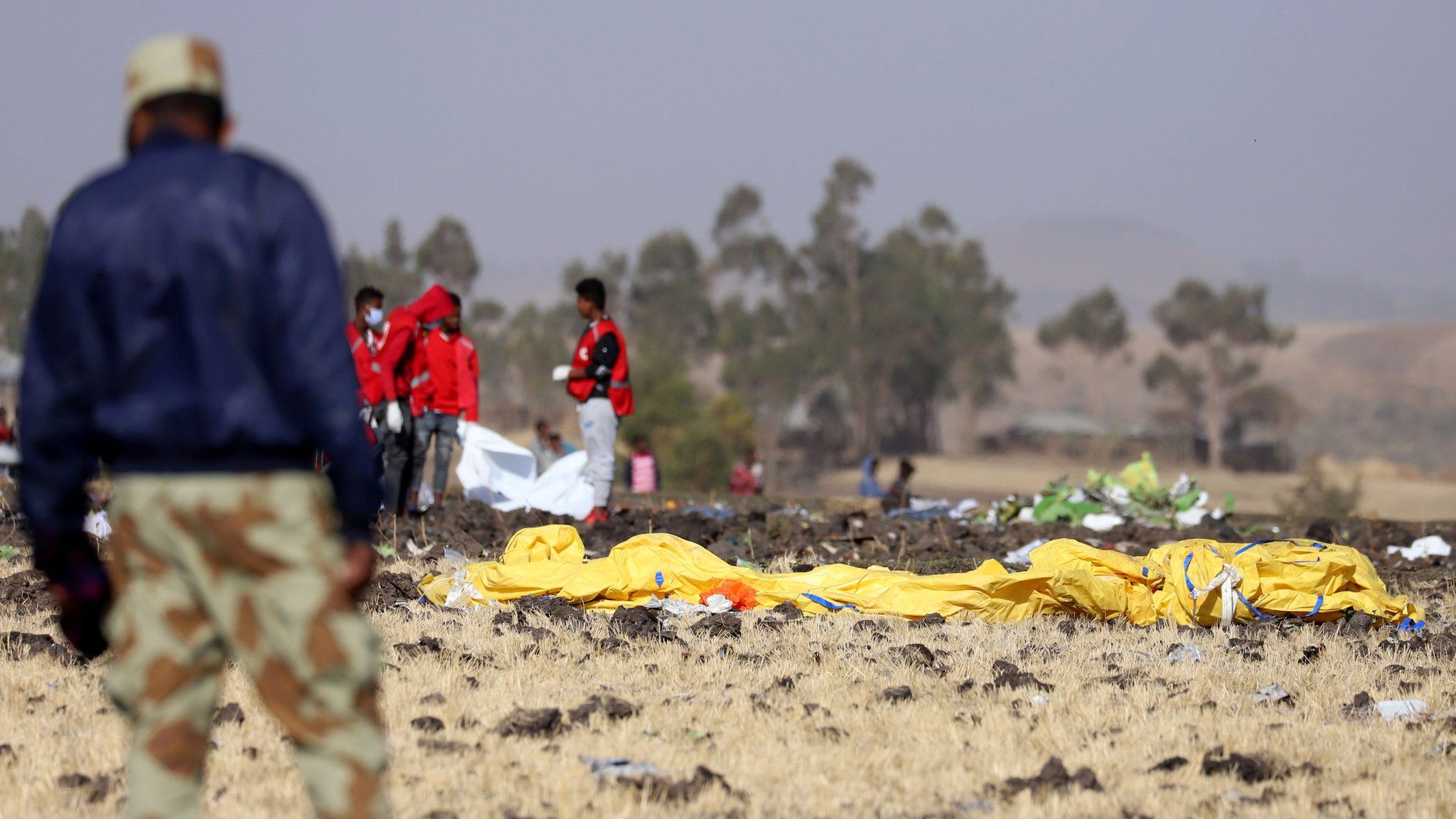Members of the search and rescue mission look for dead bodies of passengers at the scene of the Ethiopian Airlines Flight ET 302 plane crash
