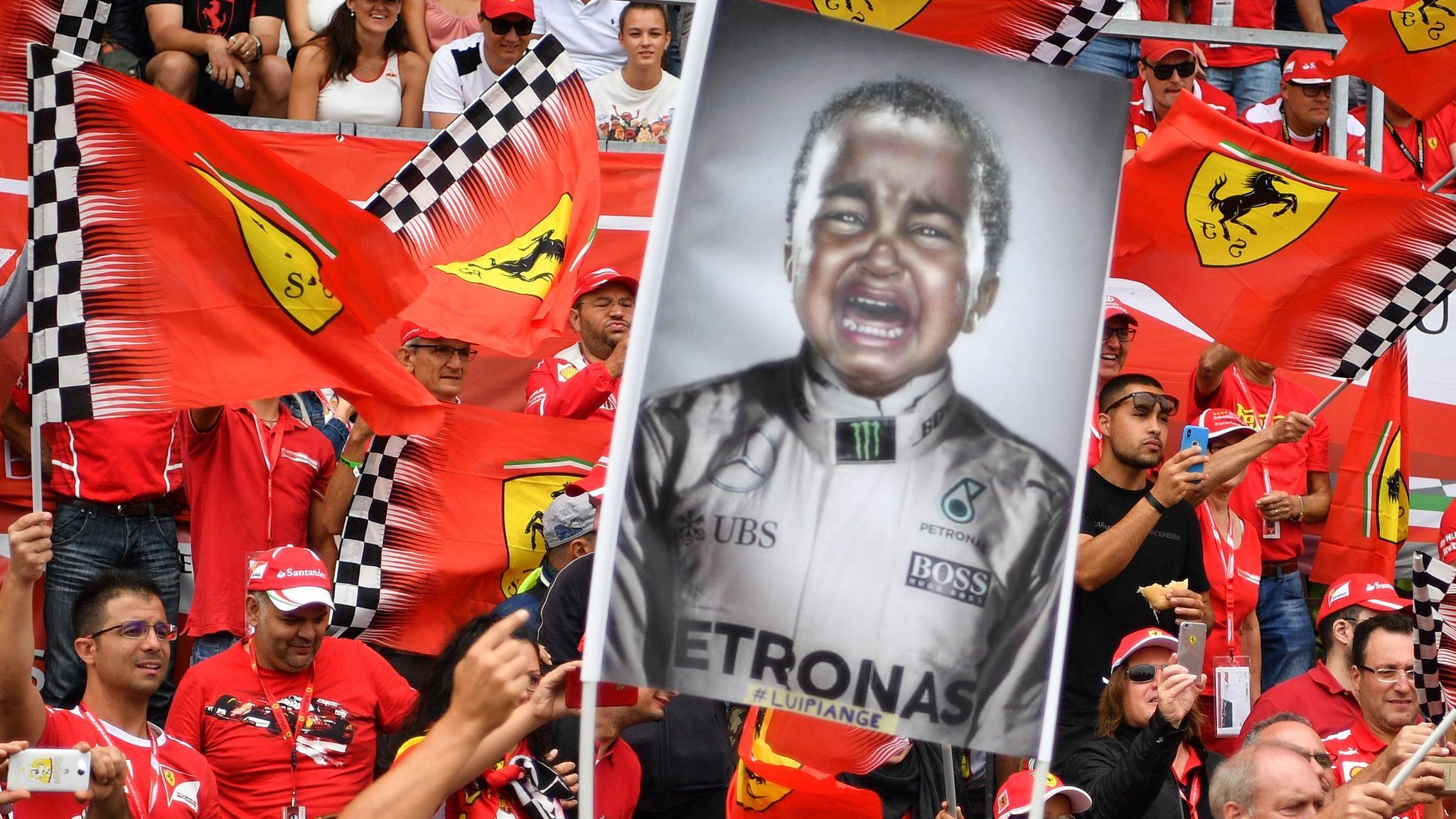 Ferrari fans hold up a sign of a crying Lewis Hamilton