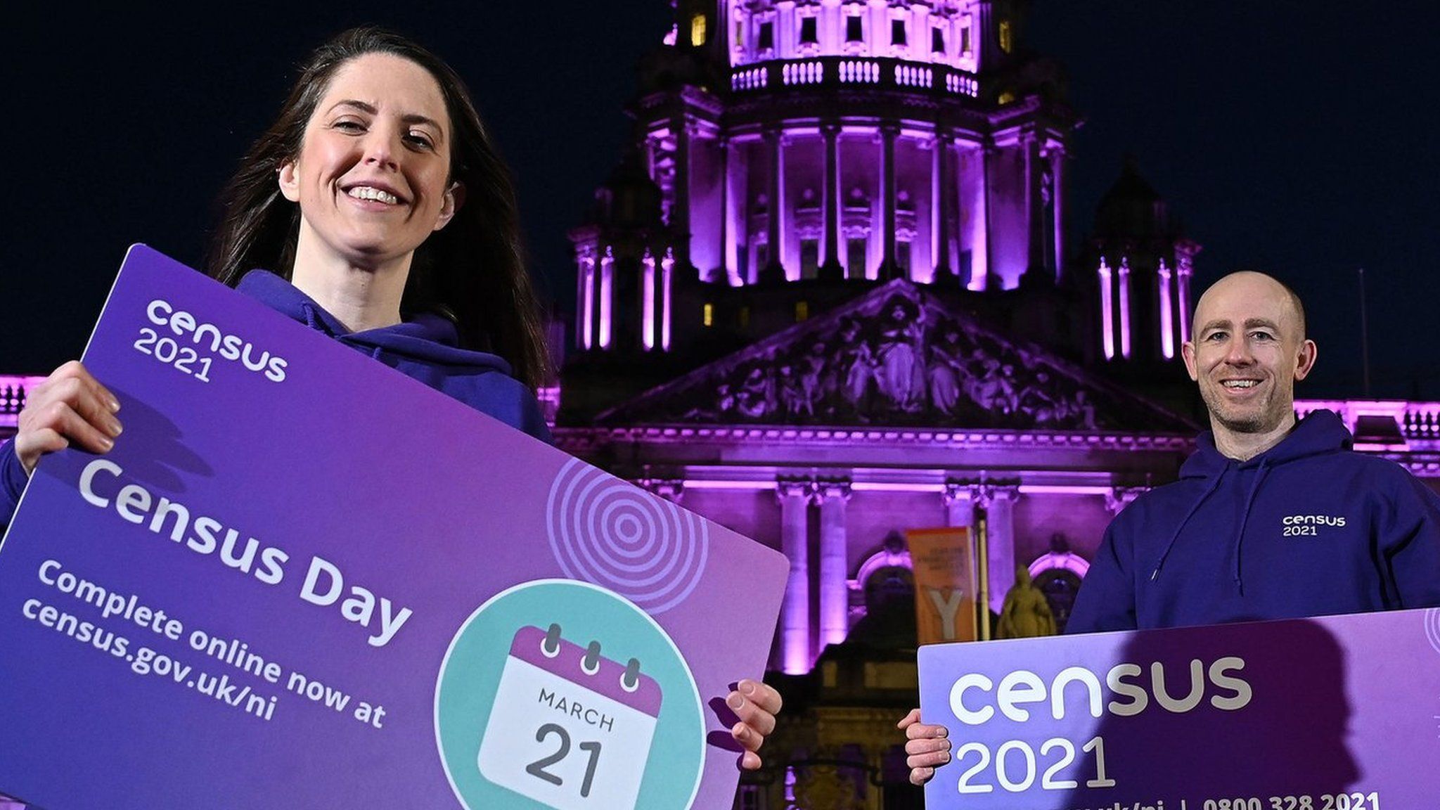 Shauna Dunlop and Conor McKiernan posing in front of Belfast City Hall to promote the census