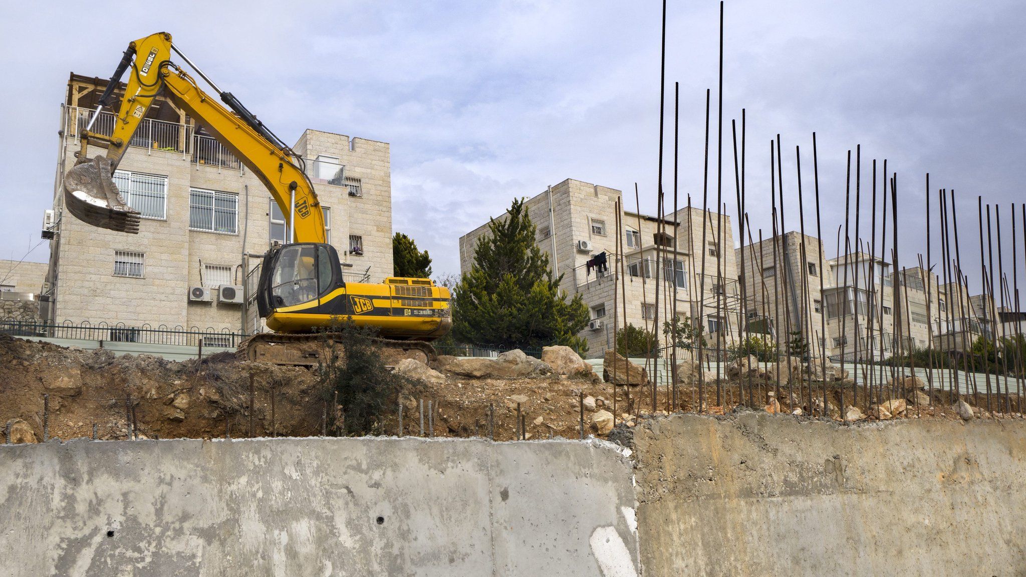 Earth moving equipment stands in the disputed Israeli "settlement" of Ramat Shlomo, 23 December 2016
