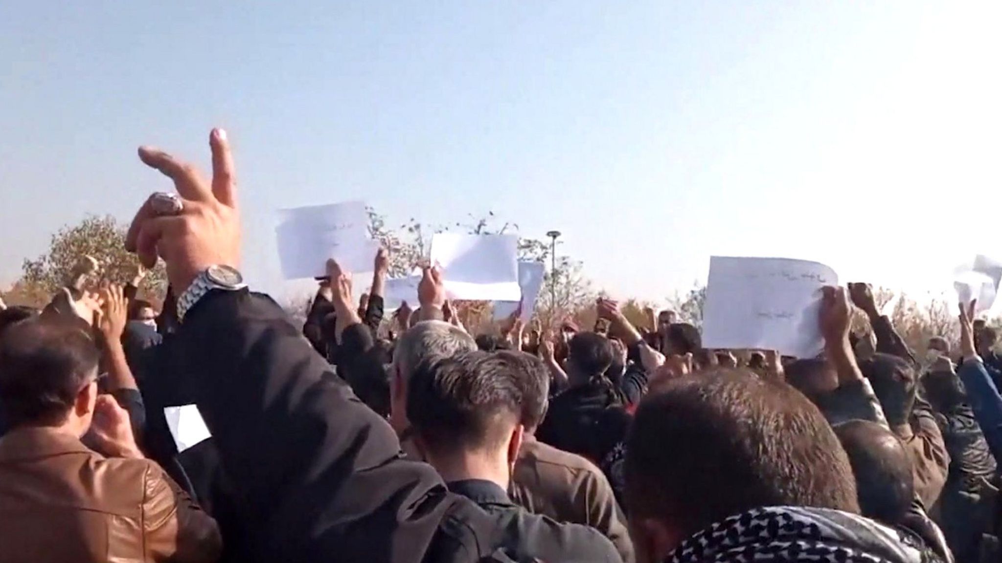 Screengrab of video posted by Kurdish human rights group Hengaw, purportedly showing a crowd protesting at the cemetery in Saqqez, Iran, where Mahsa Amini is buried (26 October 2022)