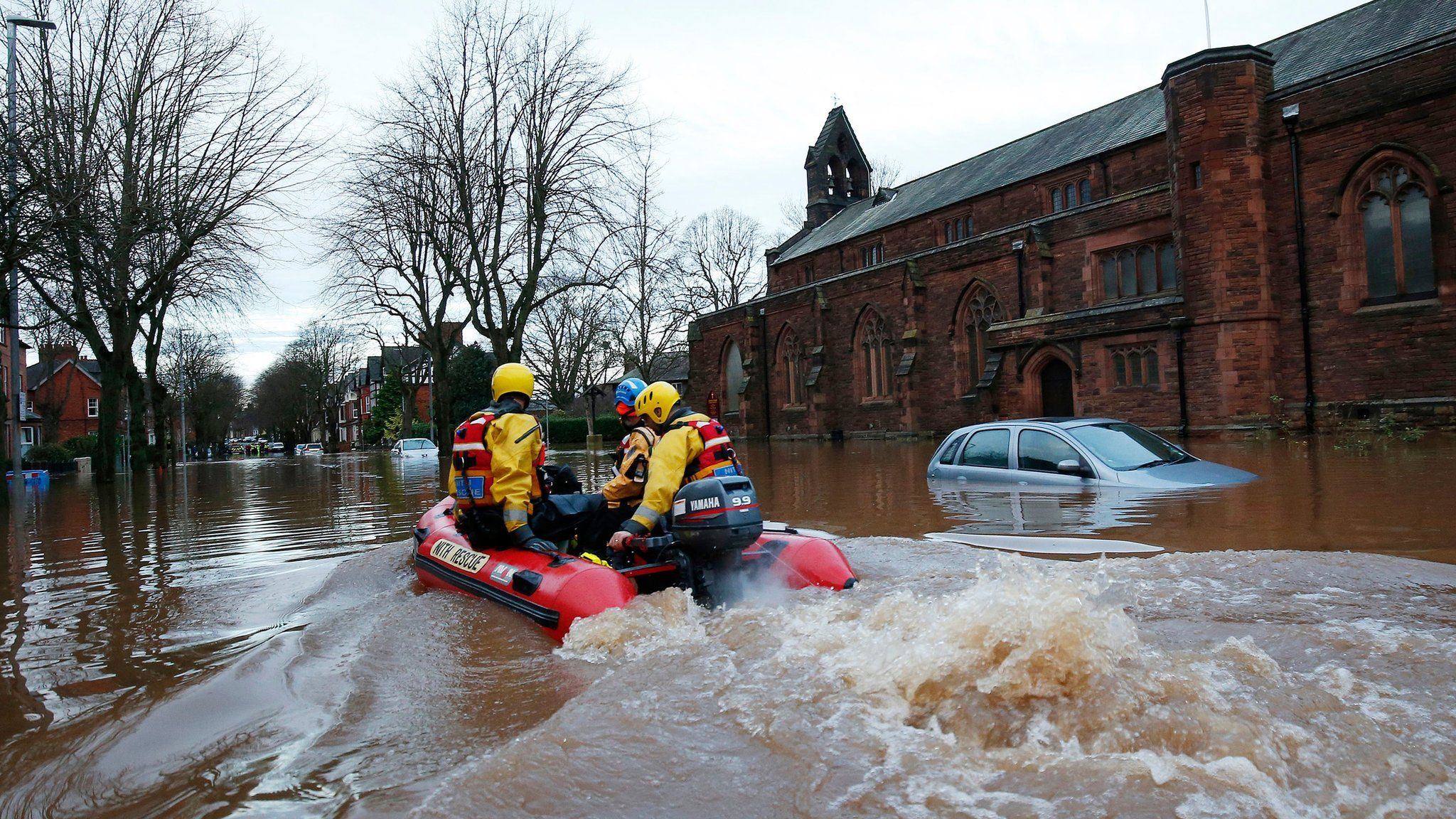 Emergency workers use a boat in floodwater on Warwick Road in Carlisle