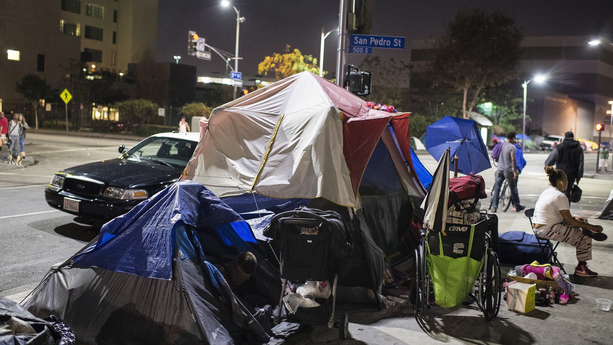 A police car stops beside tents on Skid Row in Los Angles, California, September 23, 2015