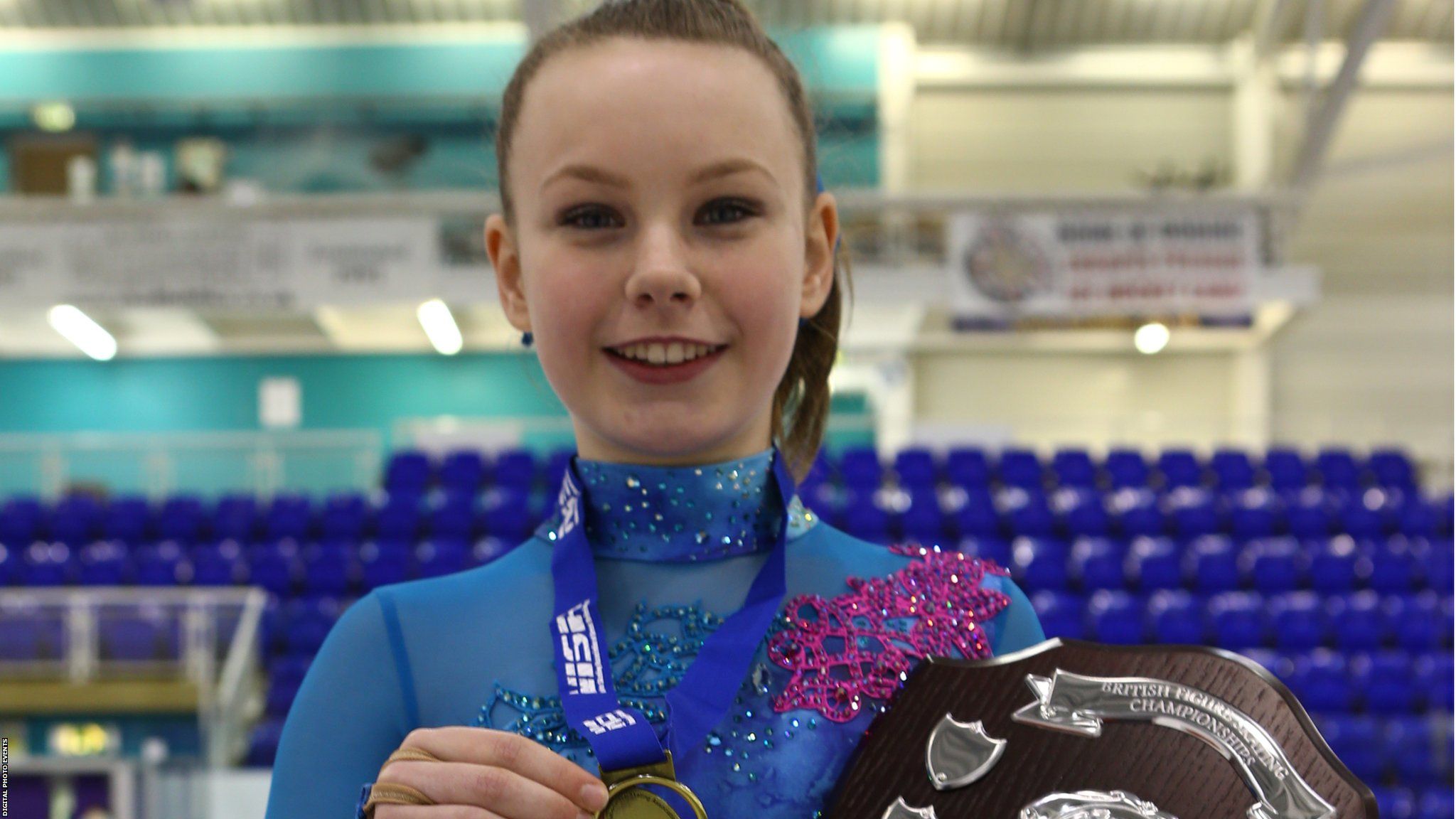 Christie Anne Shannon holds the trophy for winning the Basic Novice A British Figure Skating title
