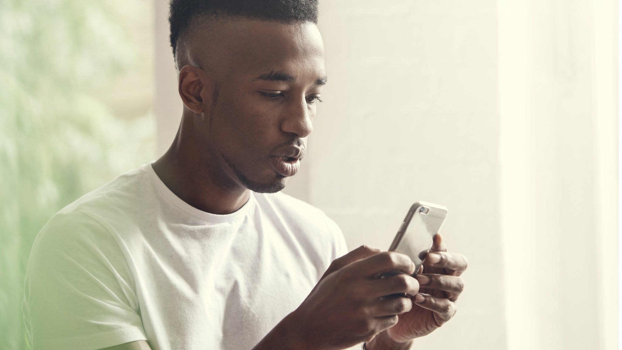 Young man texting on a phone
