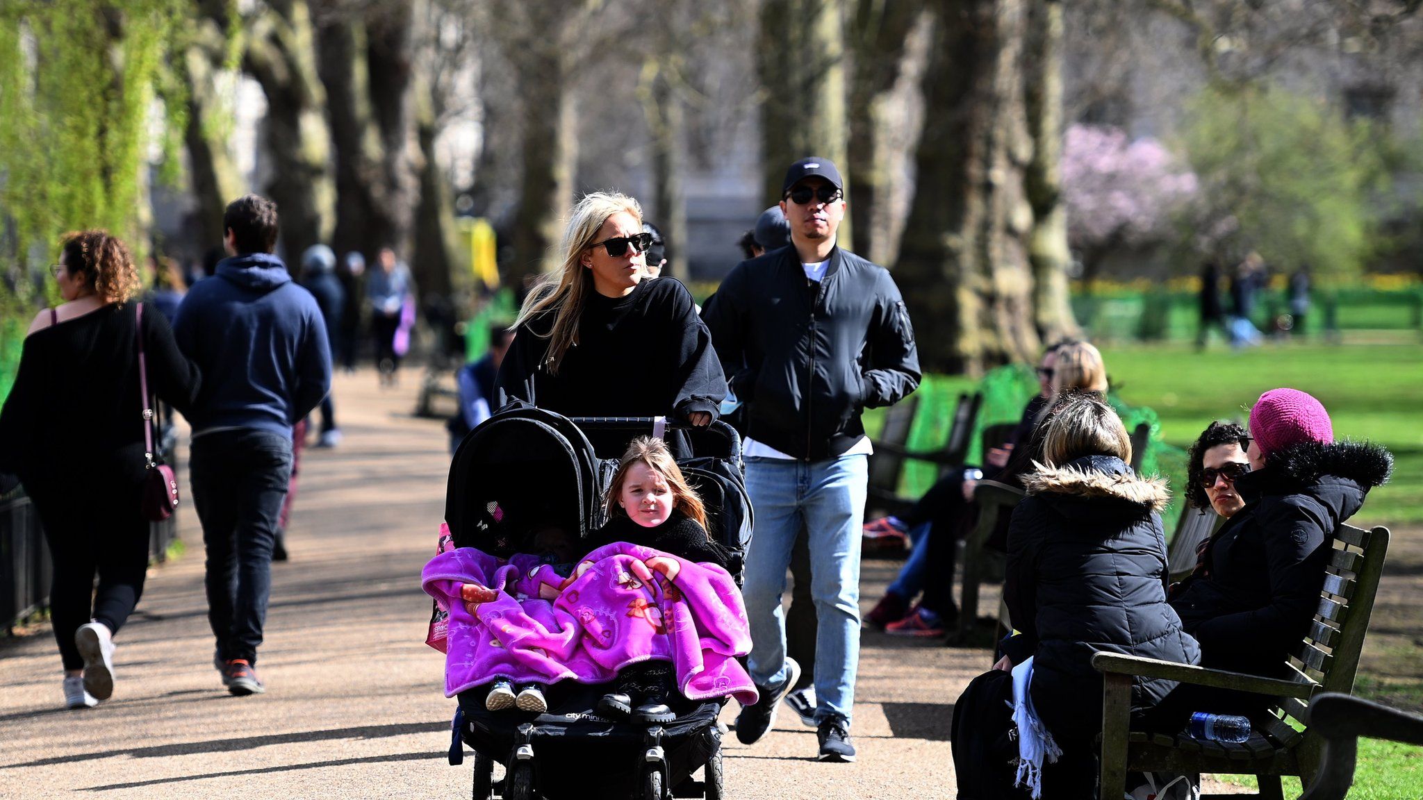 People walk through St. James"s Park in London, Britain, 27 March 2021