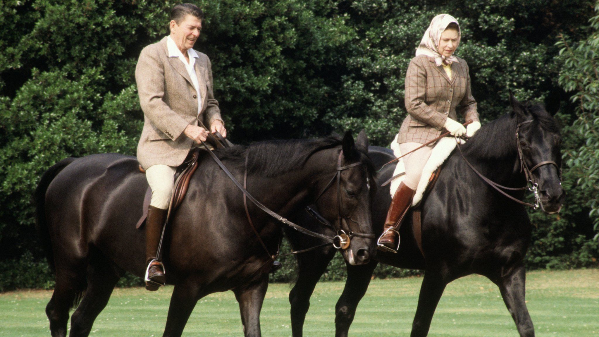 US President Ronald Reagan horse riding with the Queen at Windsor in June 1982