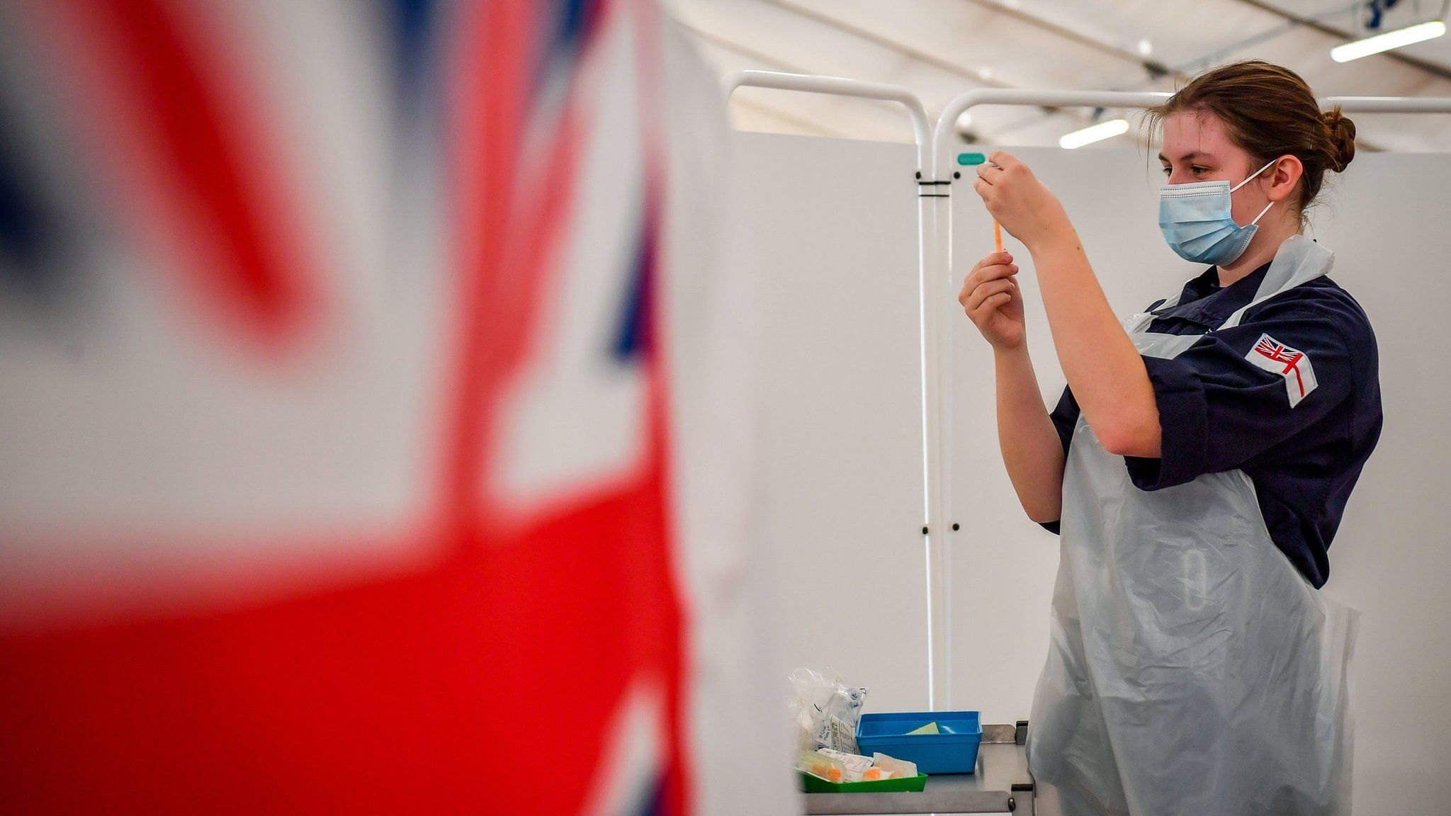 Royal Navy personnel prepare to give vaccines to the public at a coronavirus vaccination centre set up at Bath Racecourse