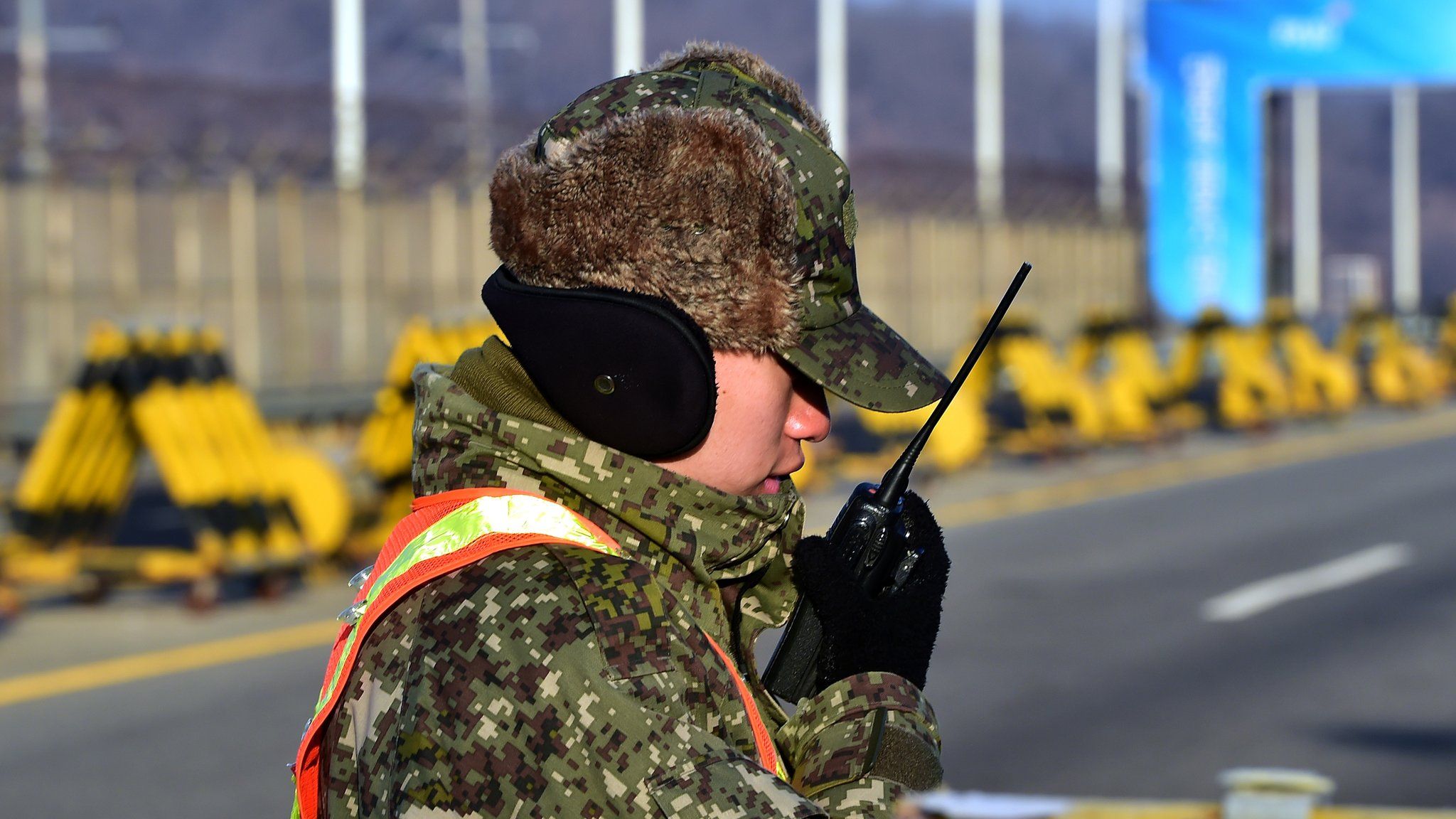 A South Korean soldier talks over a radio on the road leading to North Korea's Kaesong joint industrial complex at a military checkpoint in the border city of Paju near the Demilitarized zone dividing the two Koreas on January 8, 2016