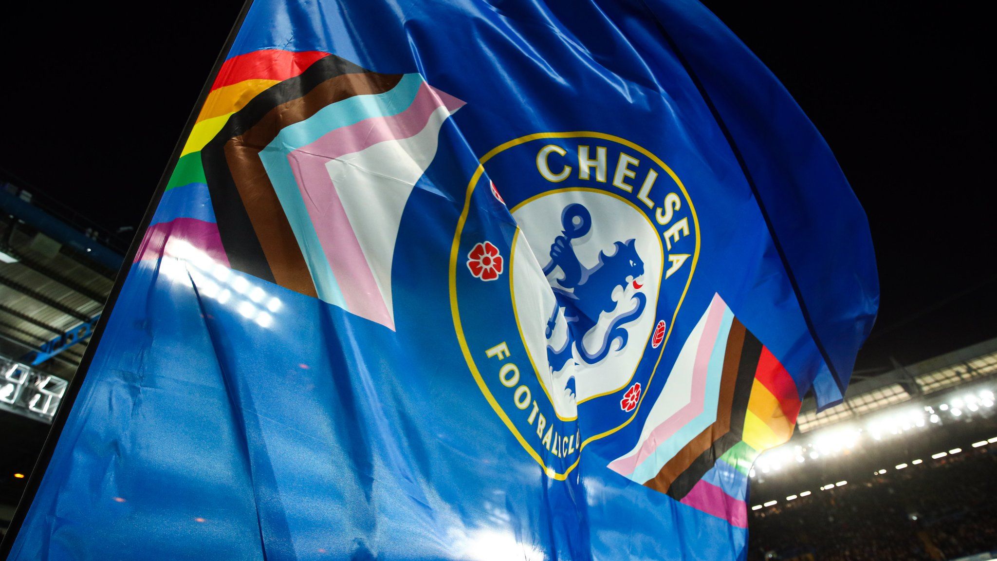 The rainbow colours either side of the Chelsea badge on a blue flag as part of the rainbow laces campaign