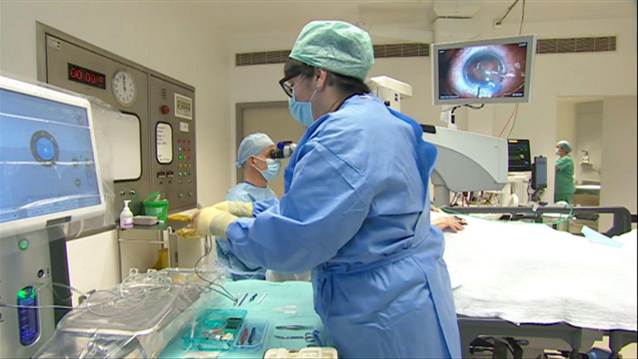 Surgeons conducting cataract surgery in an operating theatre