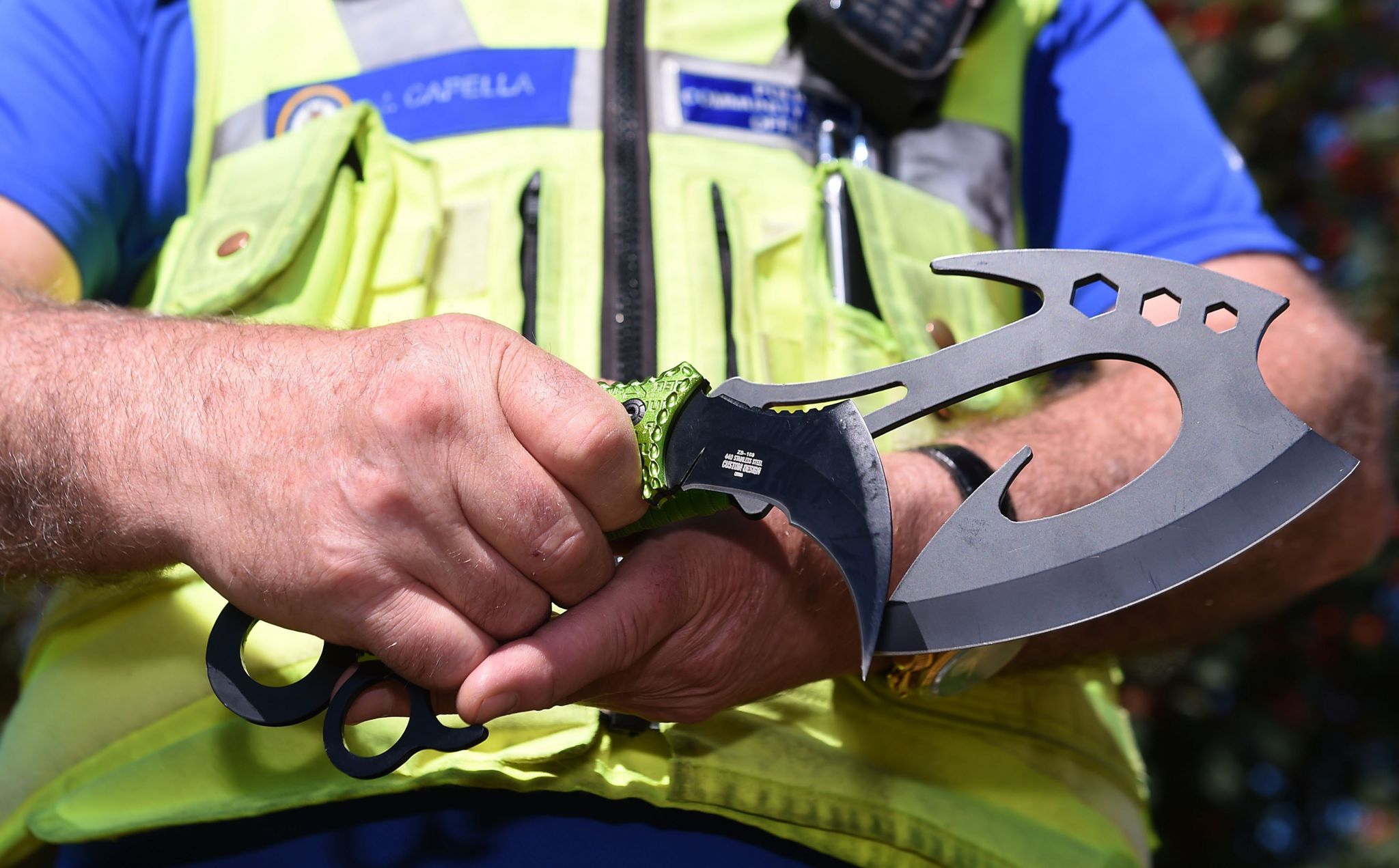 Police officer holding zombie knife