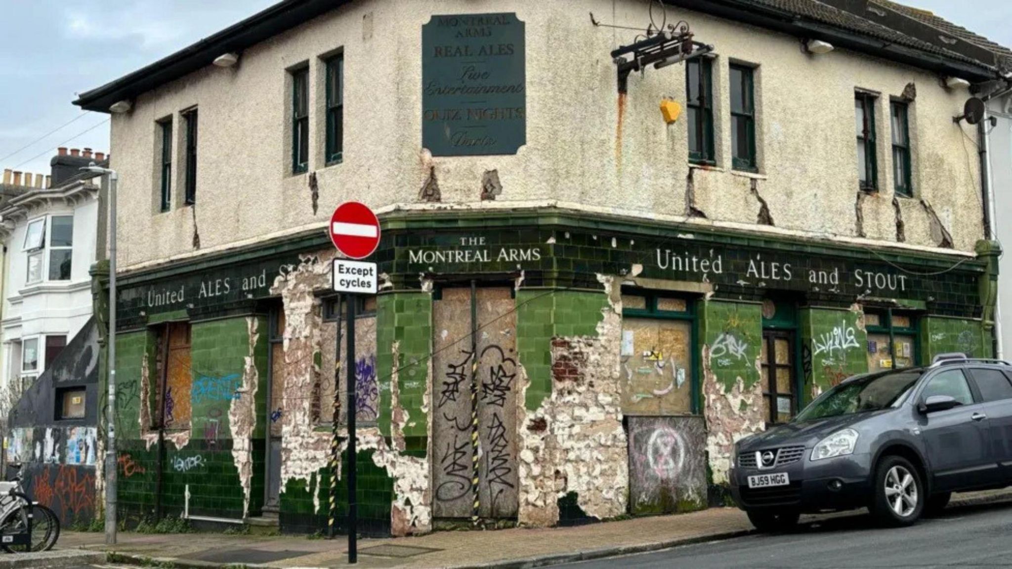 The Montreal Arms, in Brighton, with patches of its green tiling removed.