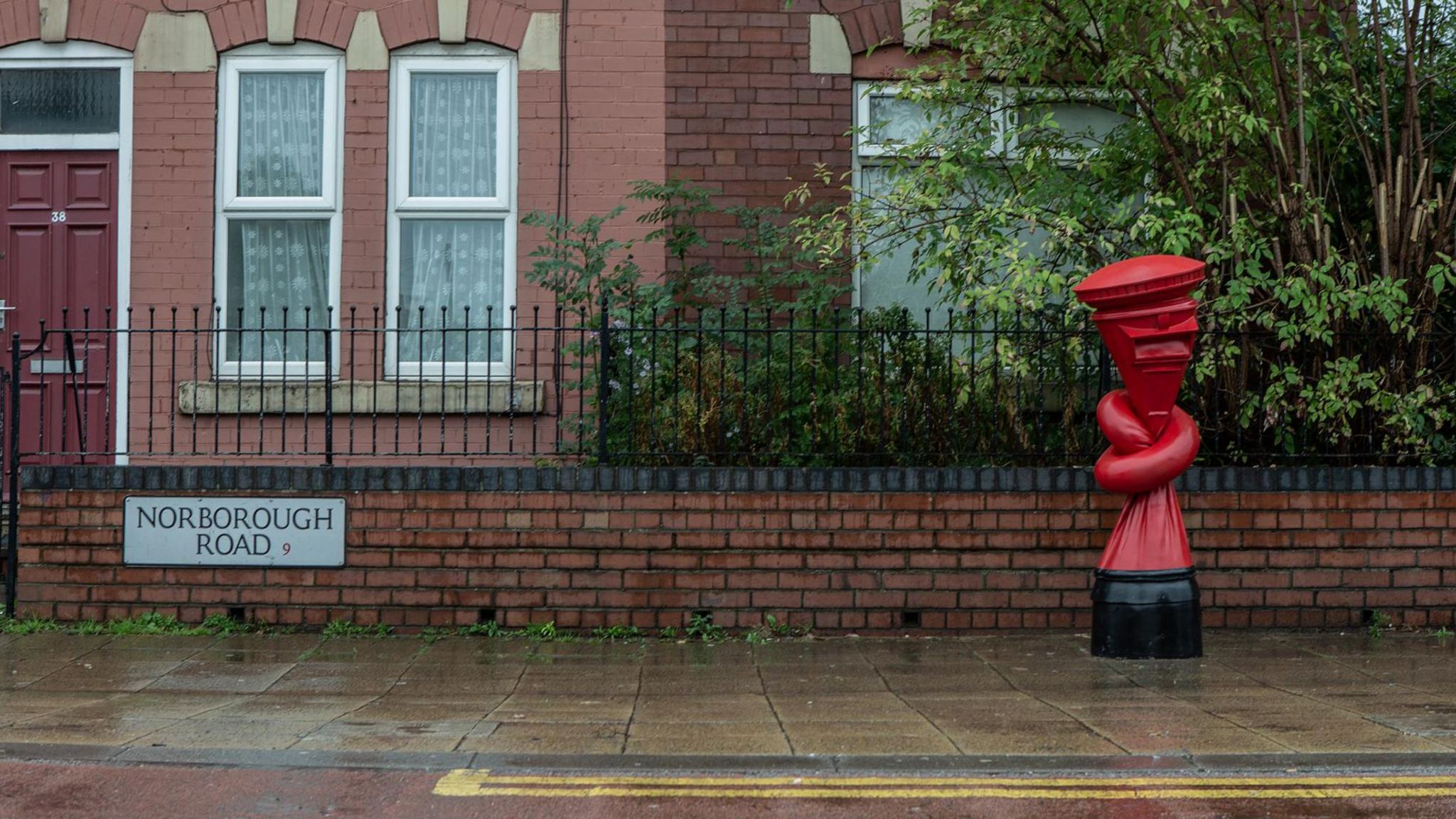 A post box tied in a knot by artist Alex Chinneck