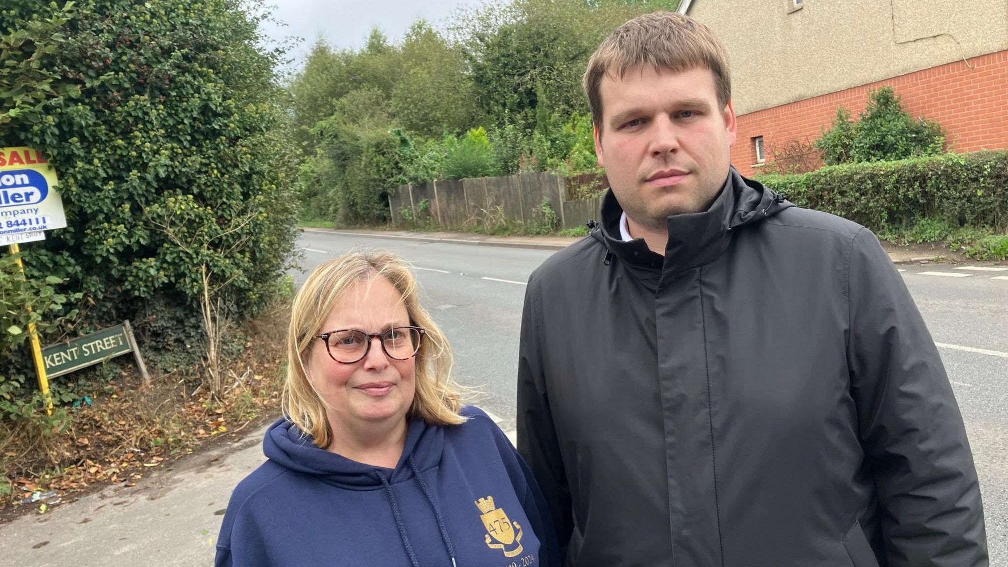 Councillors Matt Boughton and Sarah Hudson both looking at the camera and standing on the road with the Kent Street sign visible in the background