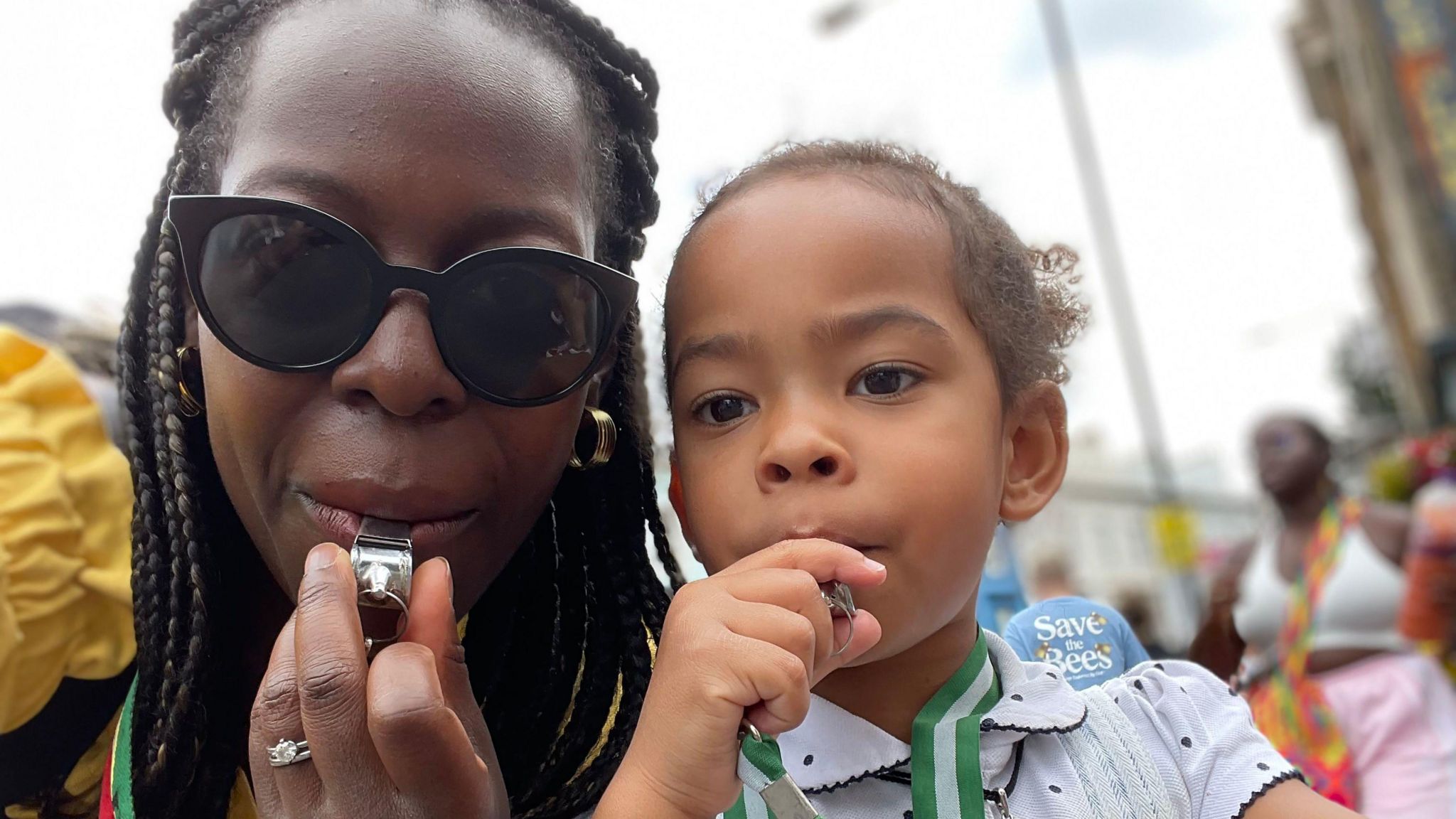 Sheyi and her daughter Isabella blowing their whistles at a previous Notting Hill Carnival