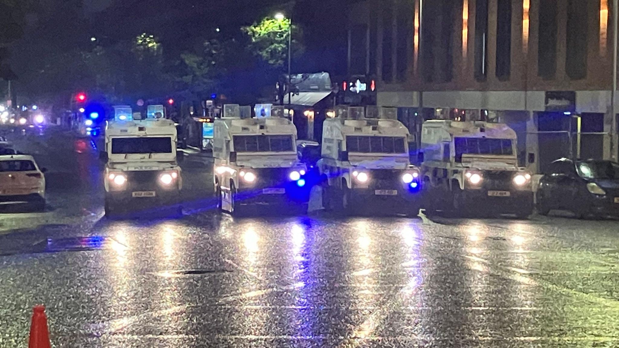 Four PSNI Land Rovers parked in line at Bradbury Place close to Sandy Row at night