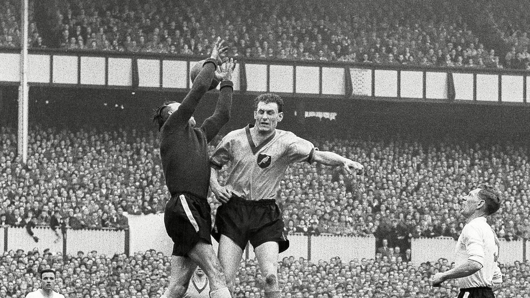 Terry Allcock challenges Luton Town keeper Ron Baynham in the 1959 FA Cup semi final at White Hart Lane   