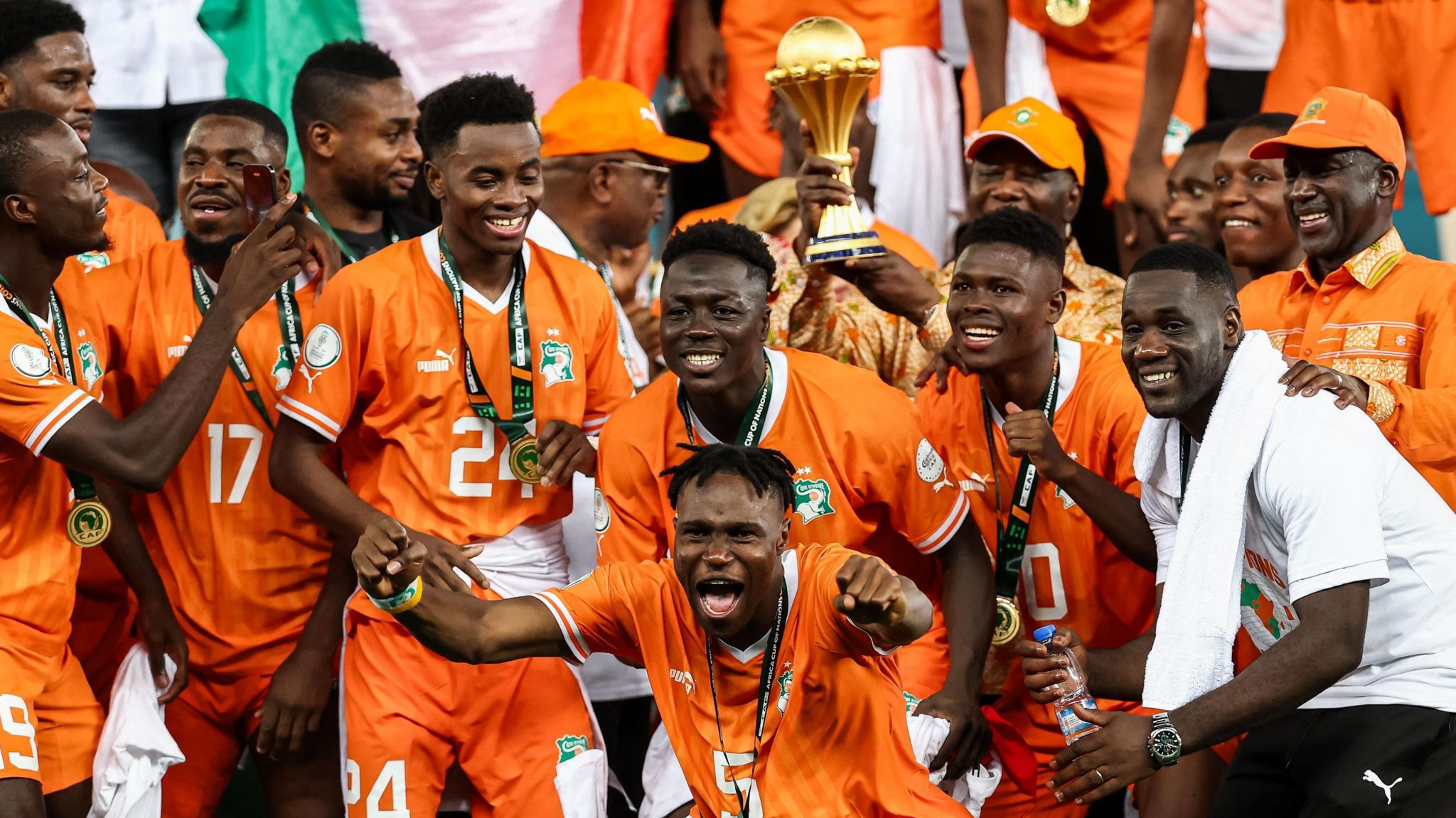 Ivory Coast players and staff celebrate with President Alassane Ouattara after winning the Africa Cup of Nations