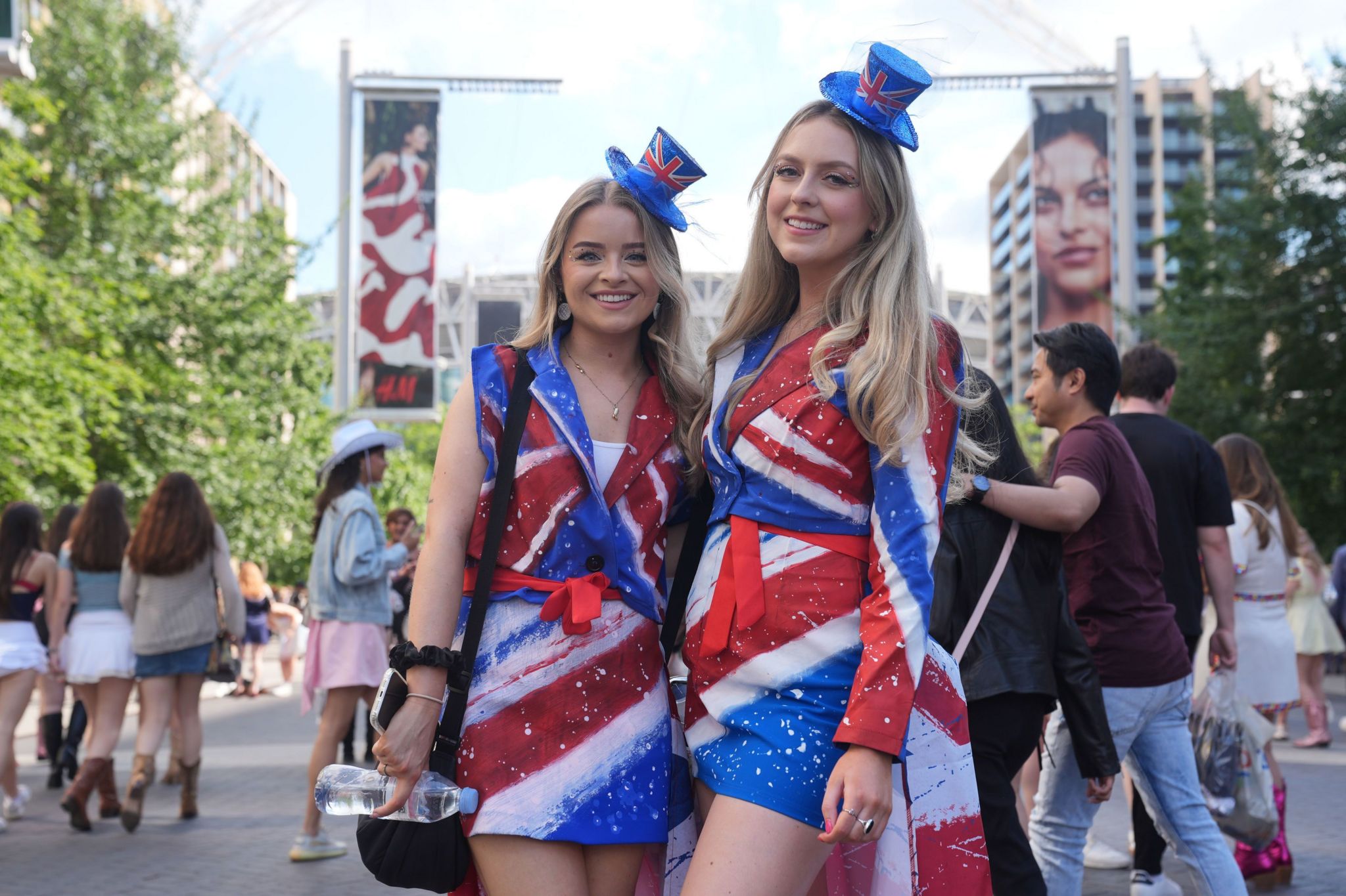 Two smiling blonde women in red, white and blue costumes with little Union Jack hats