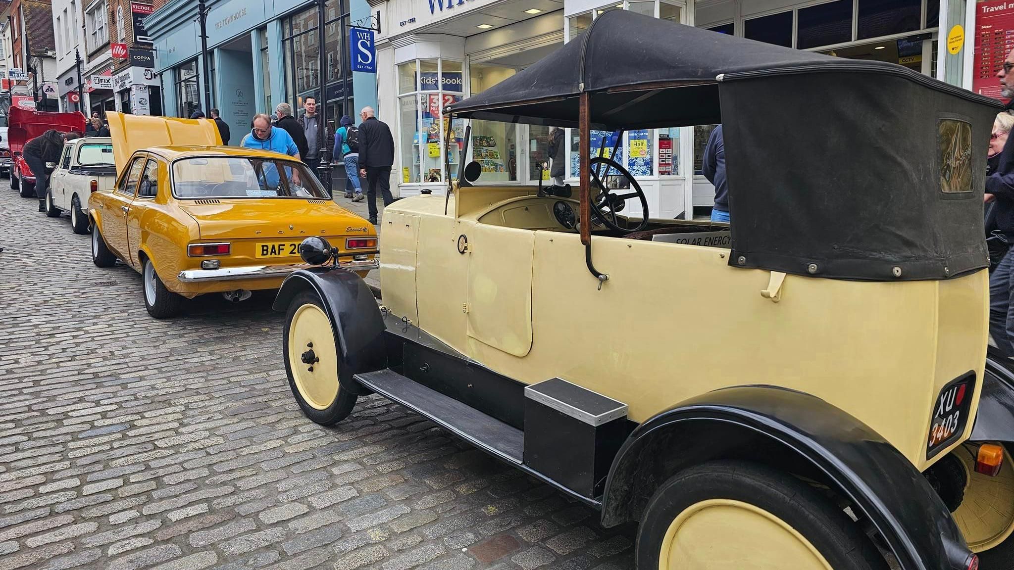 Classic cars line Guildford High Street outside WHSmith