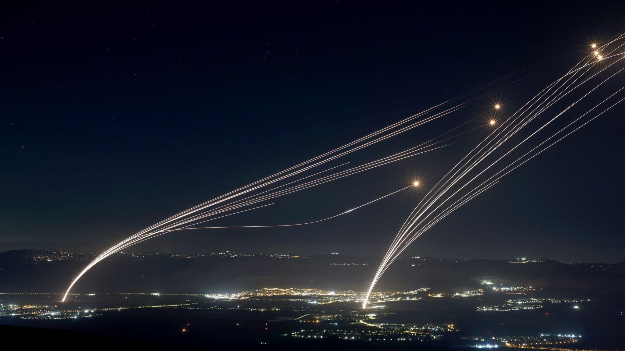 Projectiles fired from the Israeli Iron Dome air defense system to intercept missiles fired from southern Lebanon, over the upper Galilee, northern Israel, early 04 August 2024. 