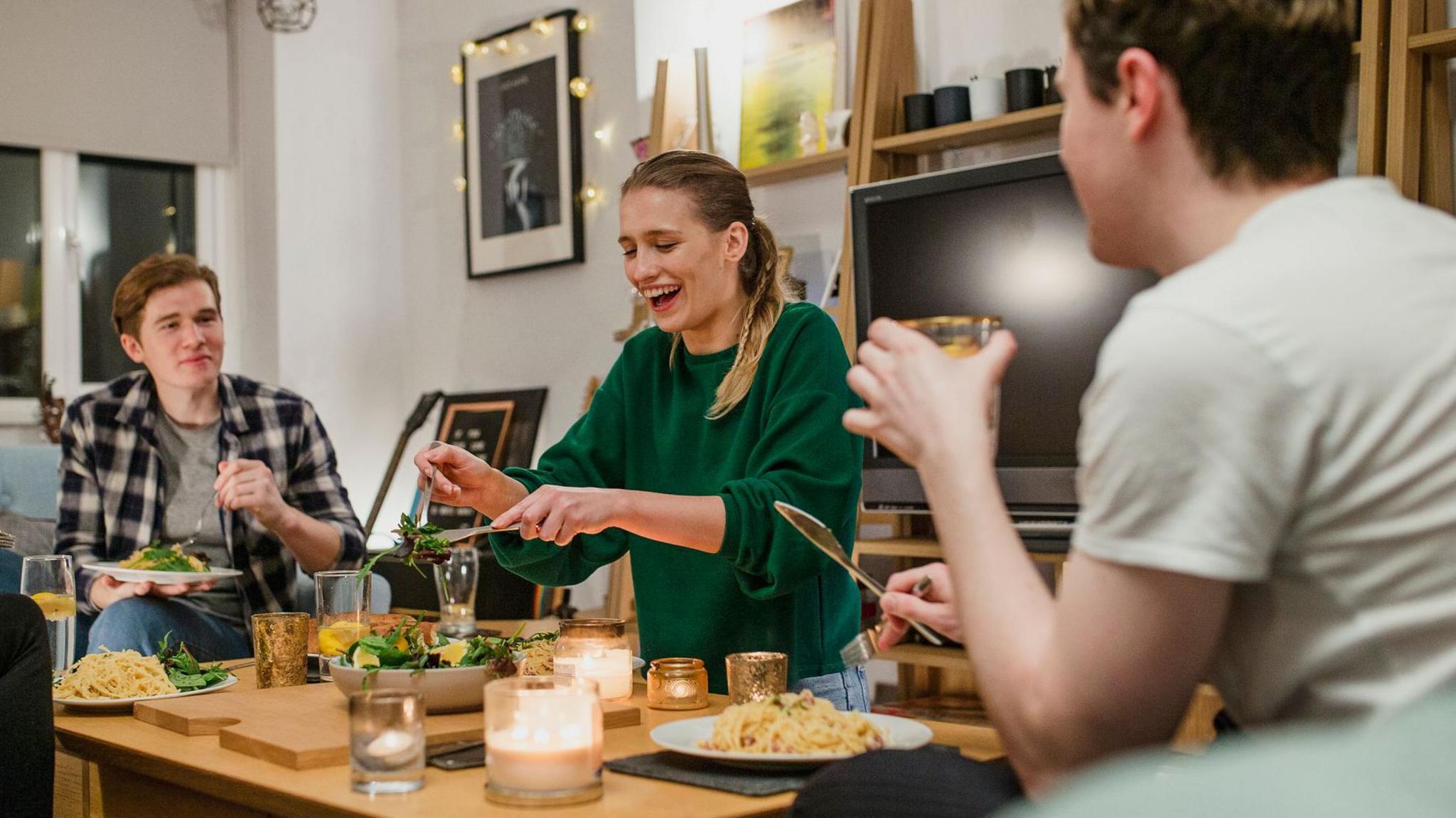 students sat around a coffee table with food