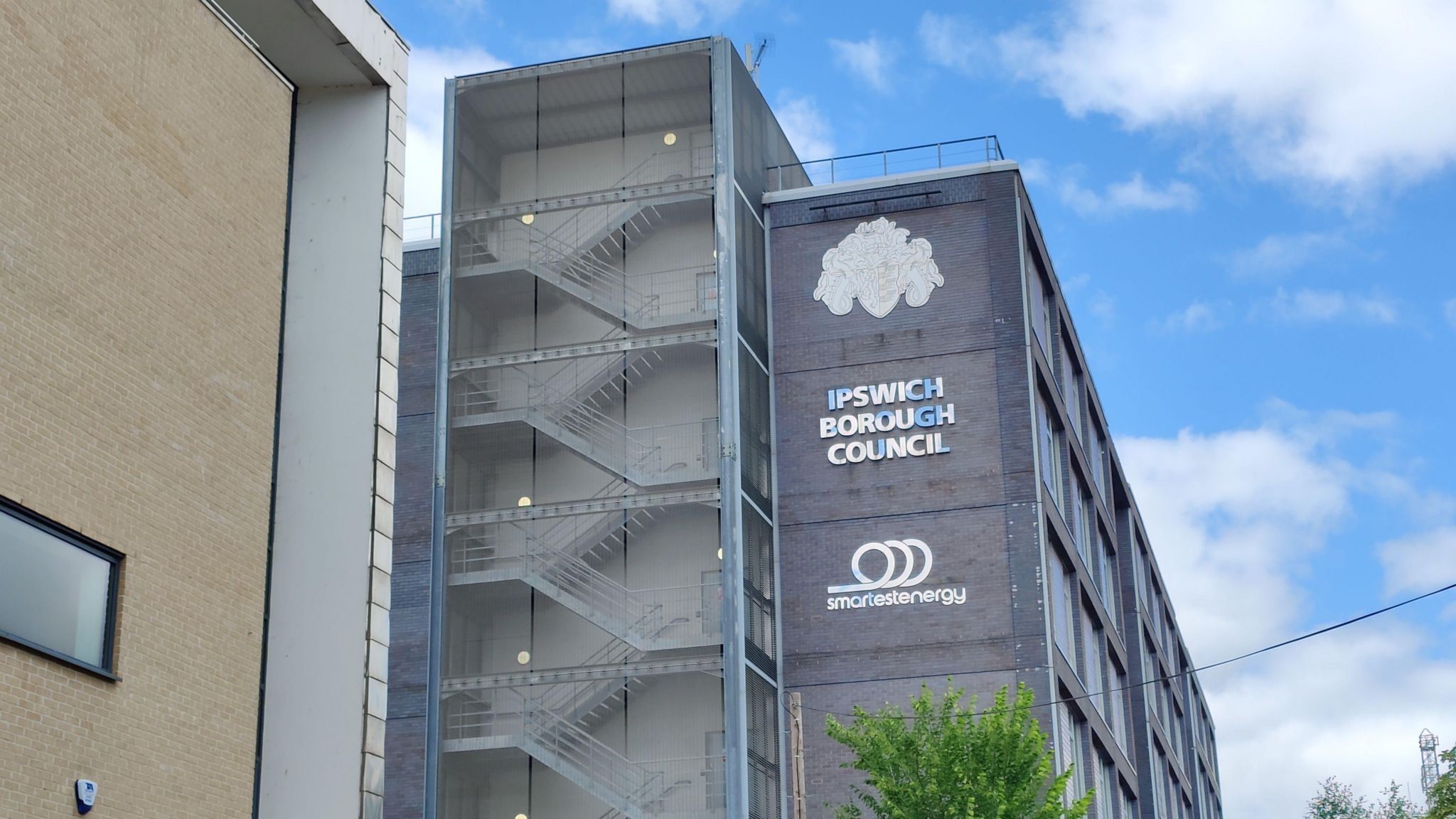 The outside of Ipswich Borough Council, a multi-storey building with a sign reading "Ipswich Borough Council"