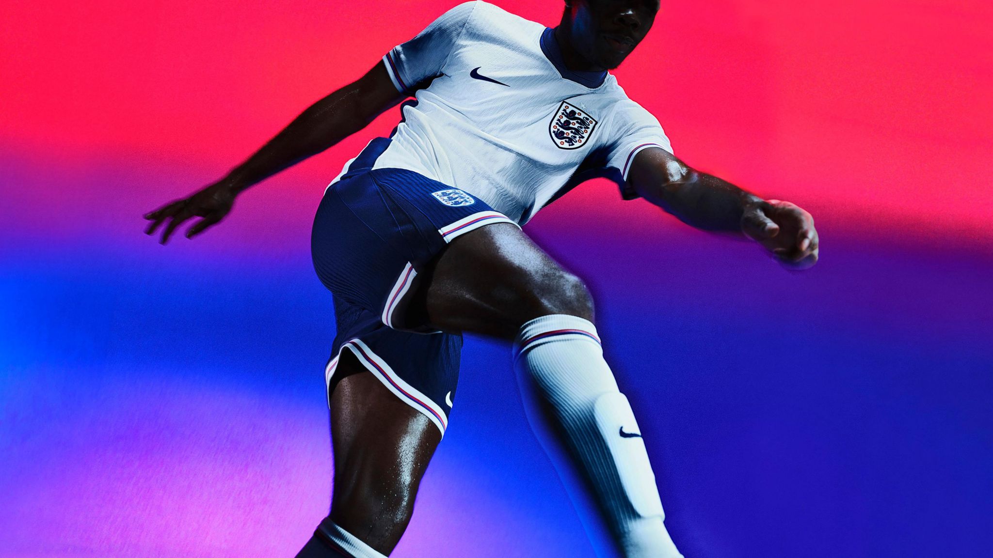 Footballer wears England shirt, shorts and socks