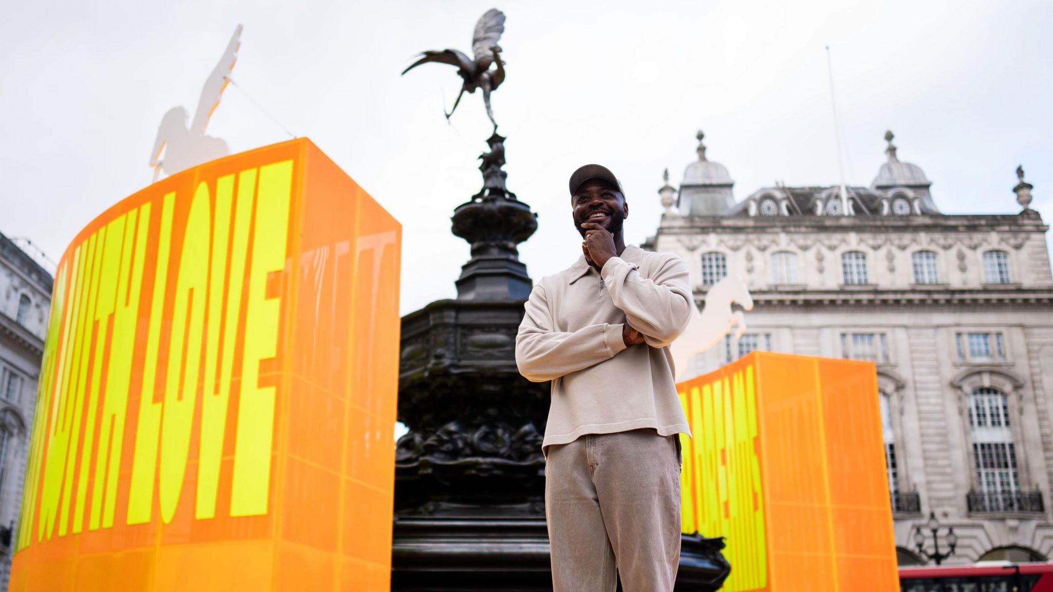 Artist Yinka Ilori in front of his installation at Piccadilly Circus 