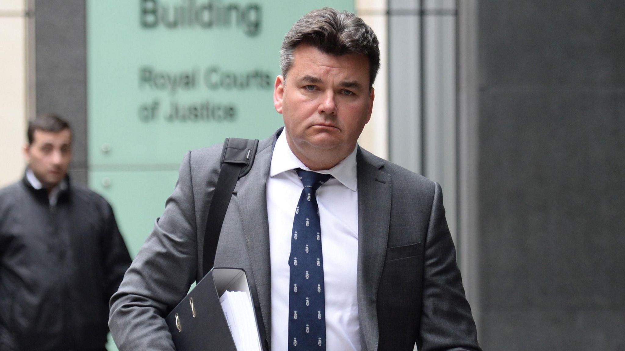 Dominic Chappell walking outside the High Court in London