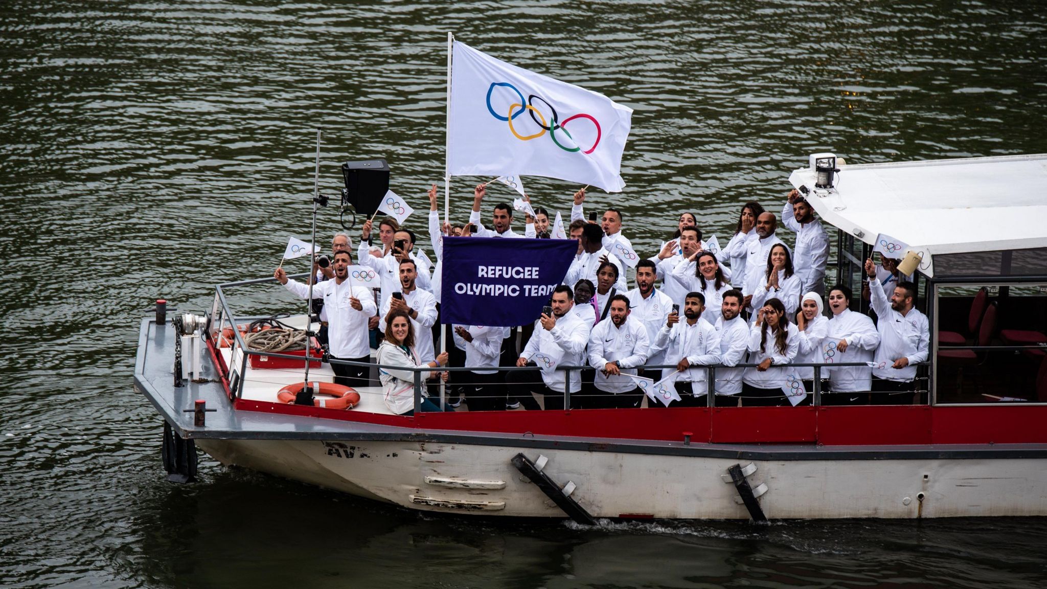 The boat carrying the Refugee Olympic Team sails down the Seine during the Paris 2024 Opening Ceremony