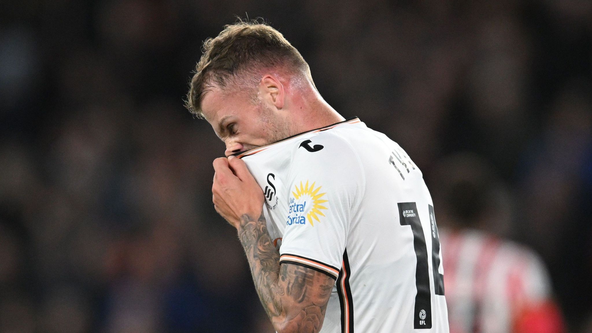 Swansea City defender Josh Tymon looks dejected after conceding an own goal