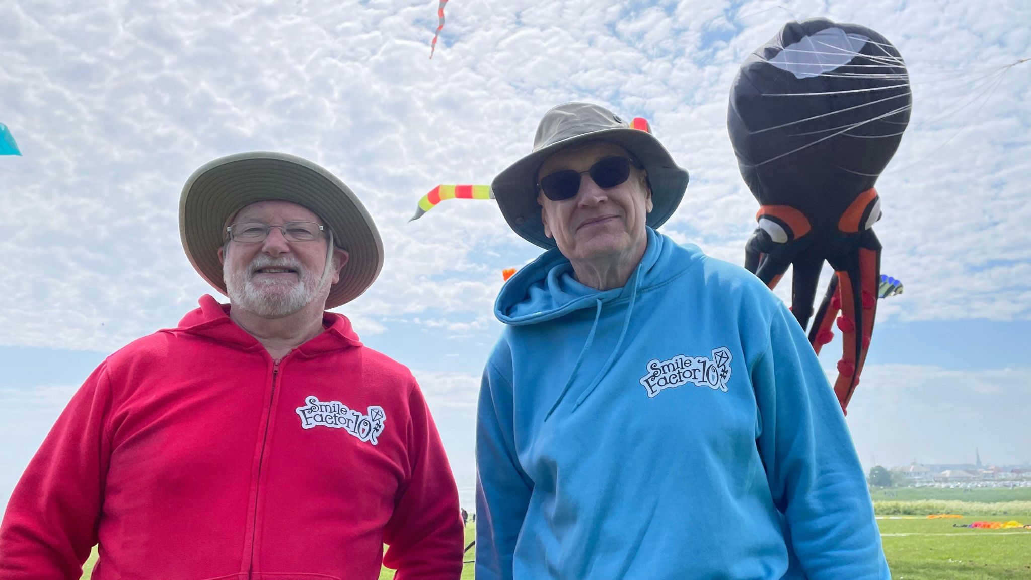 Ernie Williamson, left, and John Elvin at the Bridlington kite festival with kites in the sky behind them