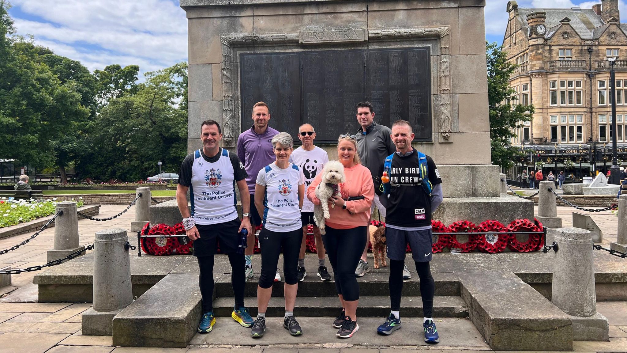Seven runners standing in front of Harrogate Cenotaph