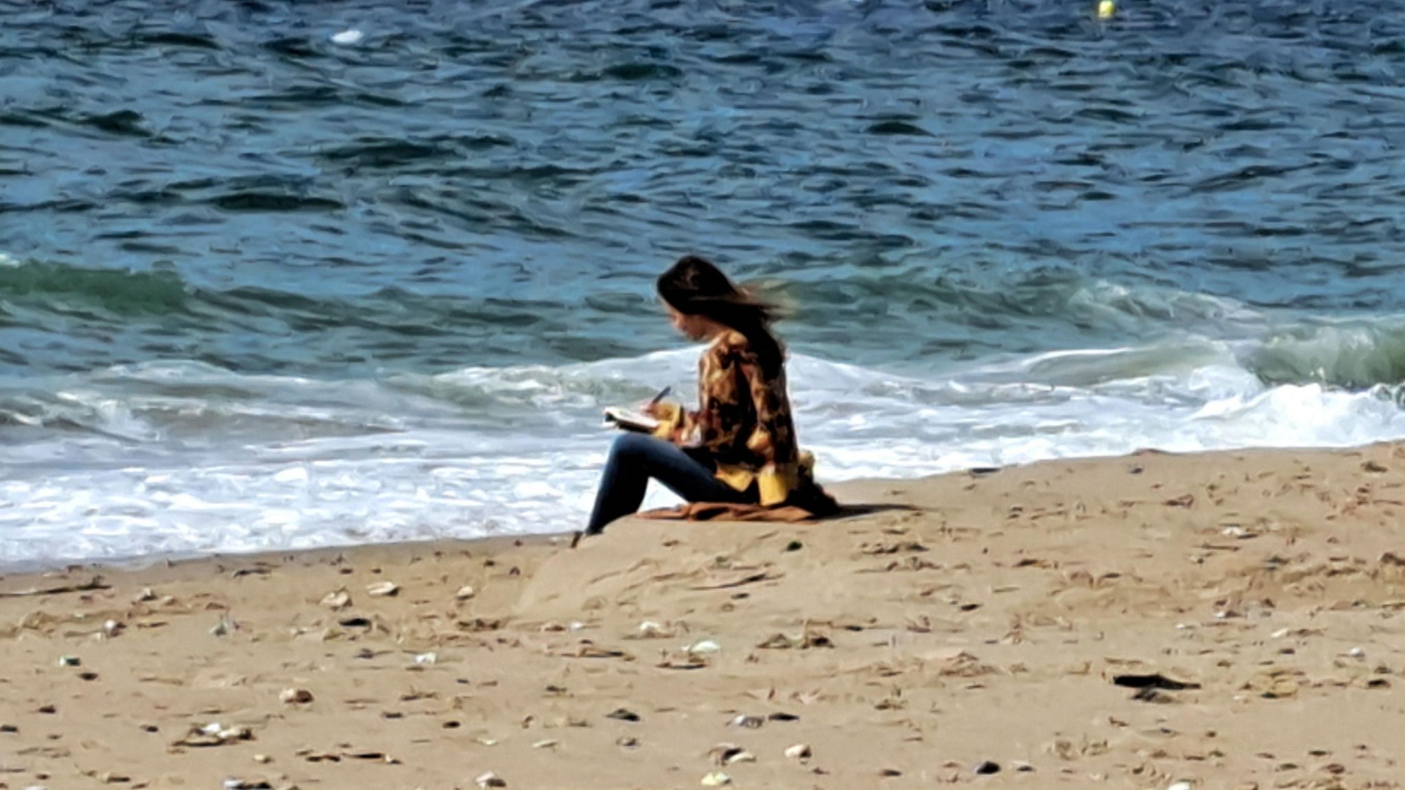 Lucy Clarke sitting on beach