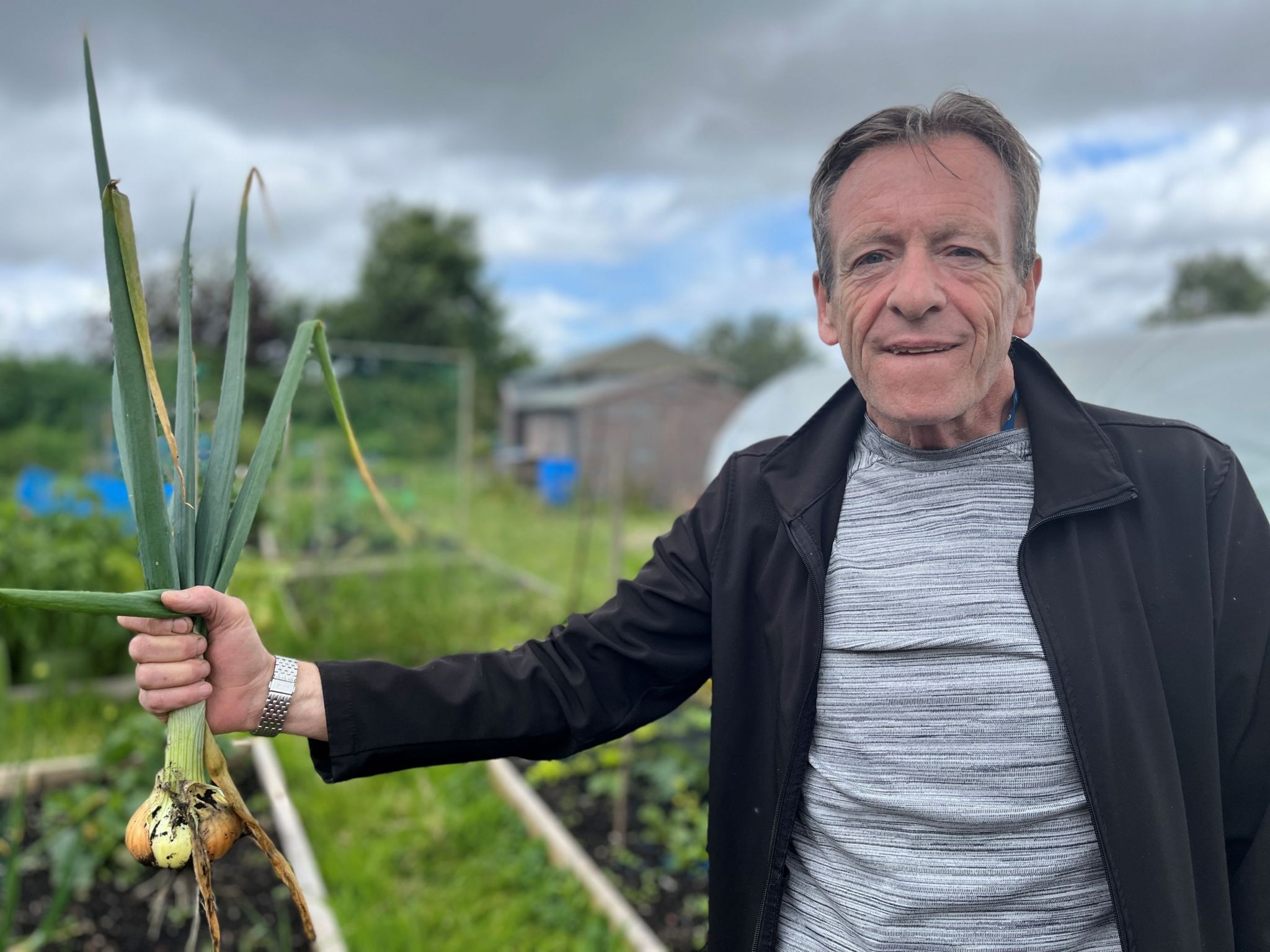 Gerry McCluskey holds a bunch of onions