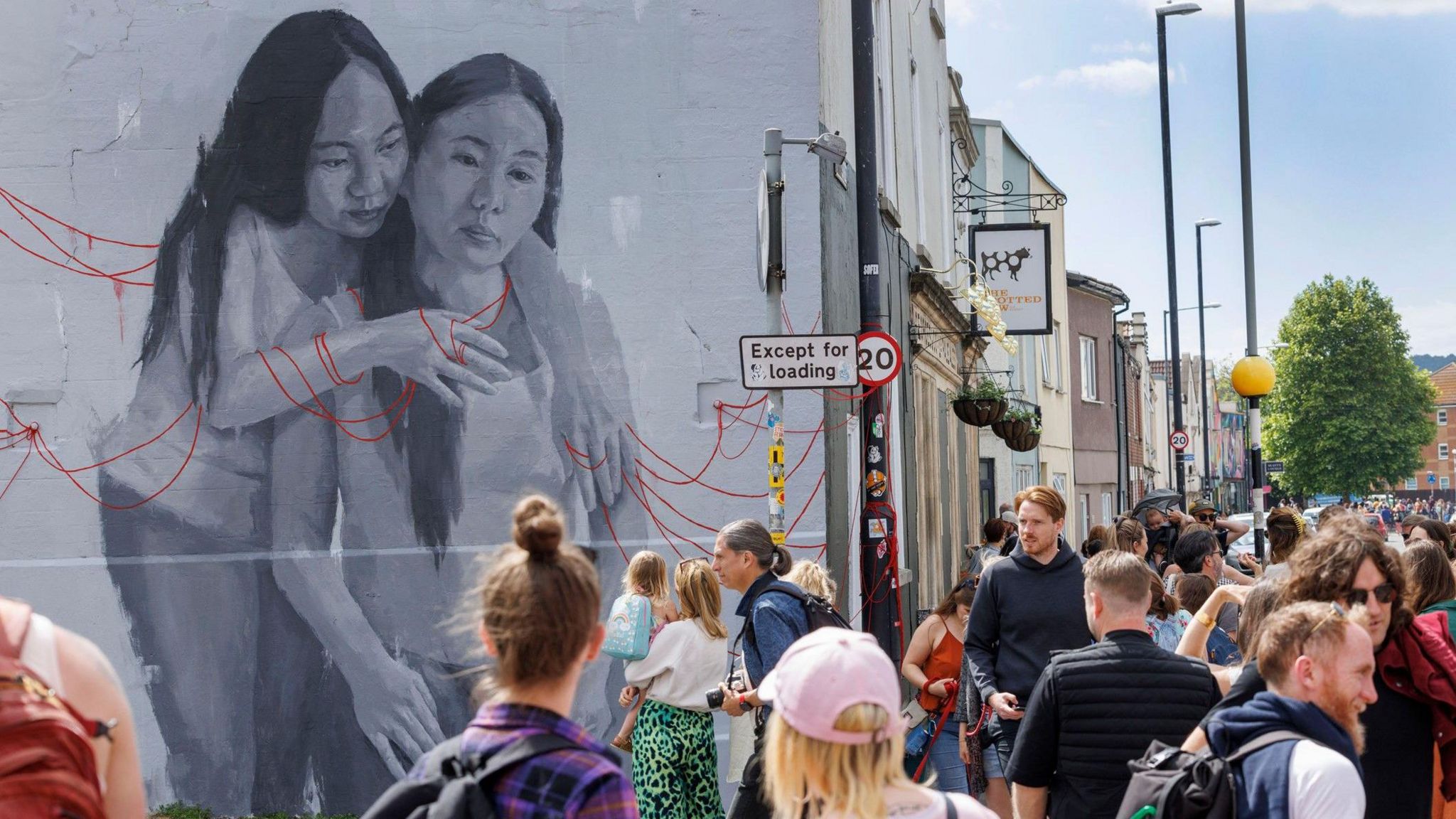 People gather around a mural in Bedminster