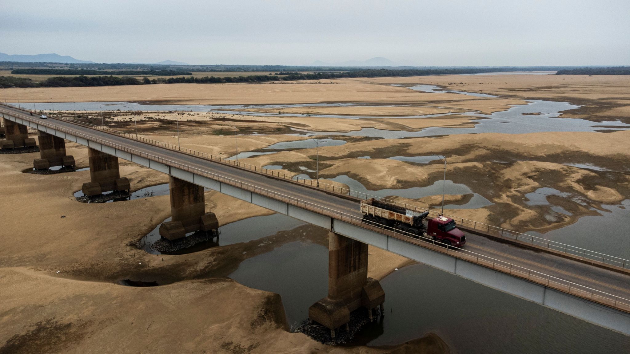Vehicles cross the Macuxis bridge above the dry and sandy Branco riverbed in Boa Vista, Roraima state, Brazil.
