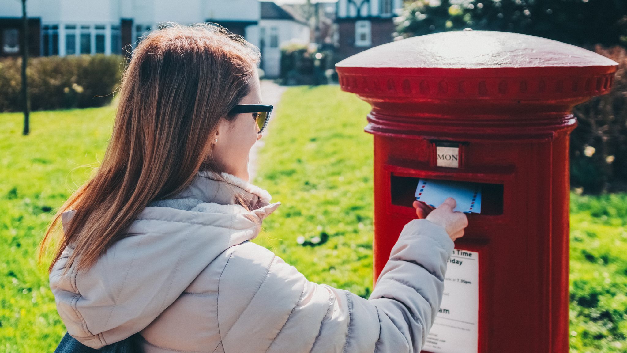 Woman in the city sending a letter