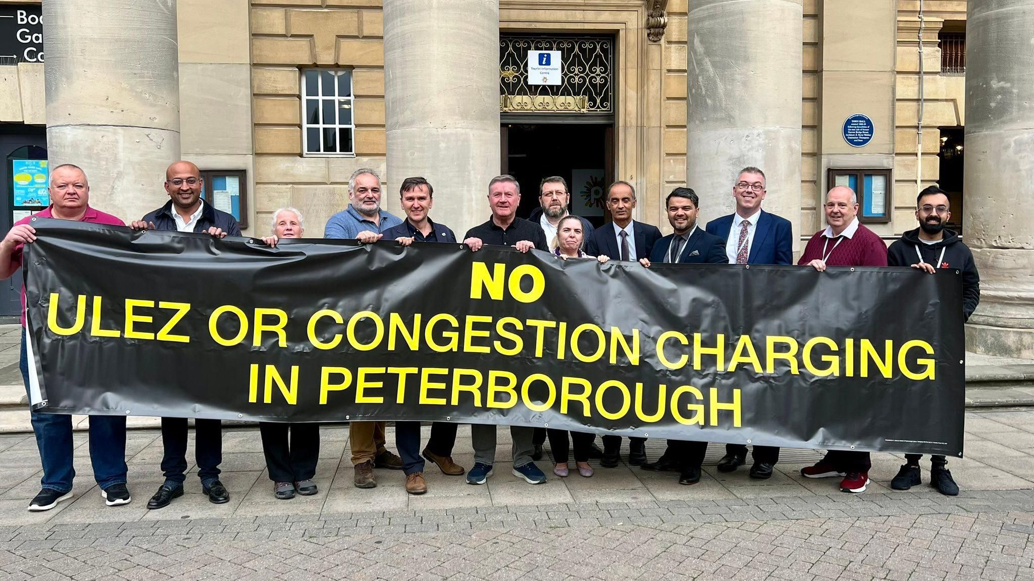 City councillors with a 'no Ulez charge' banner outside the town hall 