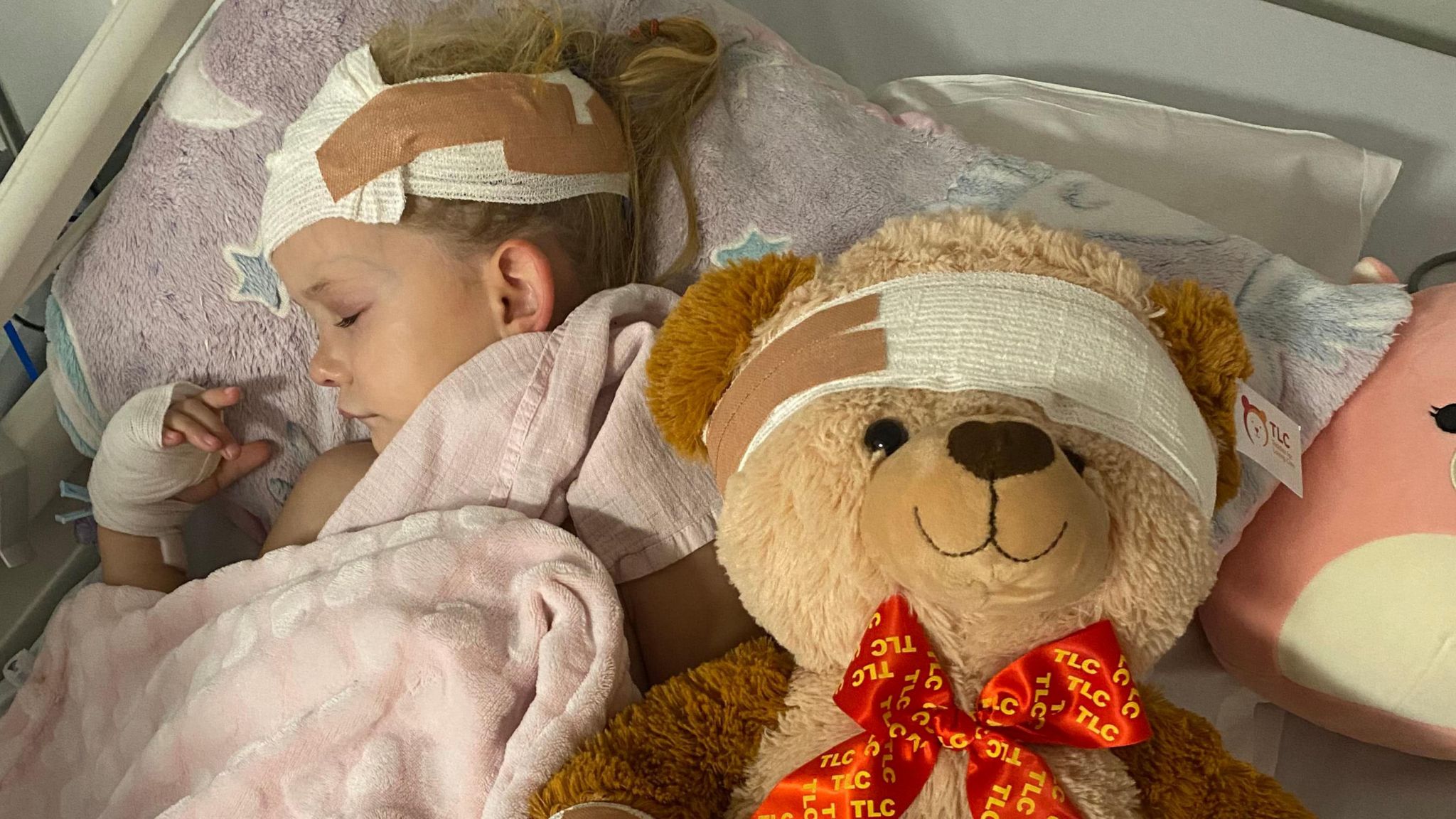 Girl in hospital bed with teddy