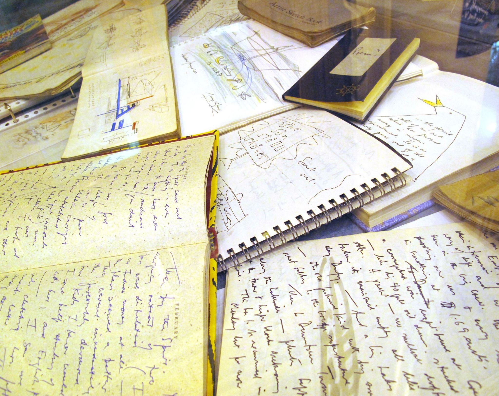 Collection of George's sketchbooks featuring writings and drawings