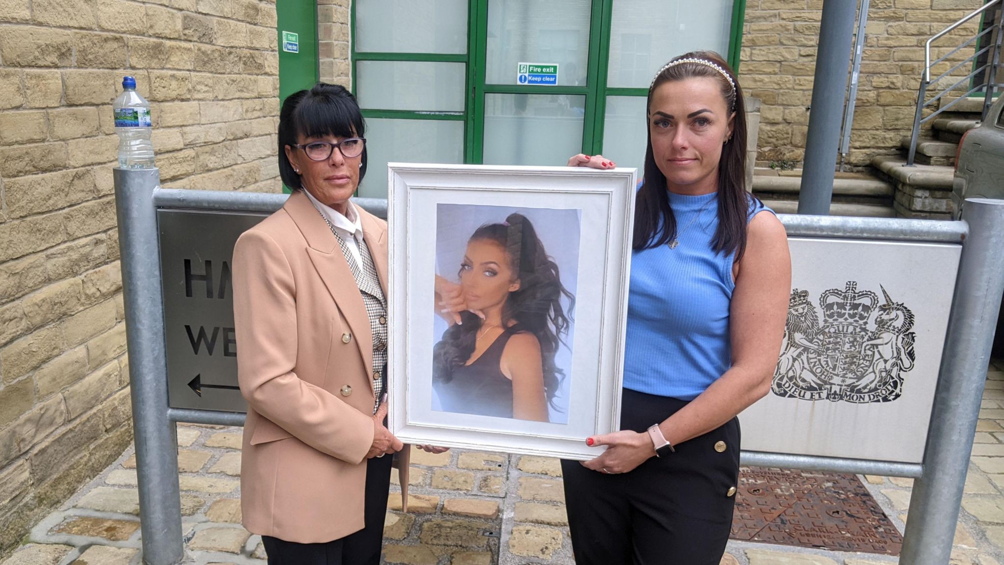 Samantha Beaumont and Nadia Brooke holding a picture of Samantha's daughter, Georgia Brooke, outside Bradford Coroner's Court
