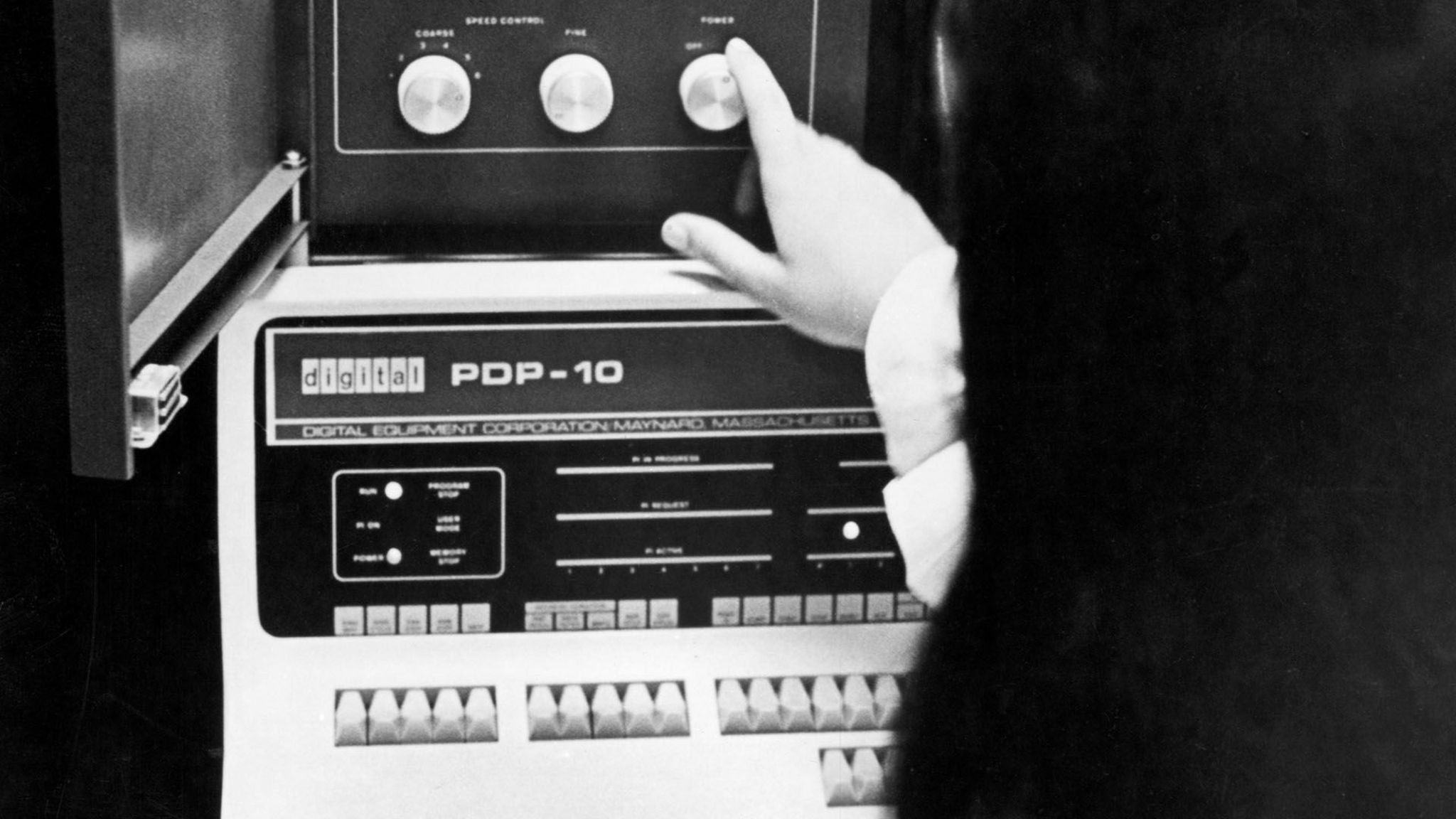 A woman shows the dials on a 1969 PDP-10 computer