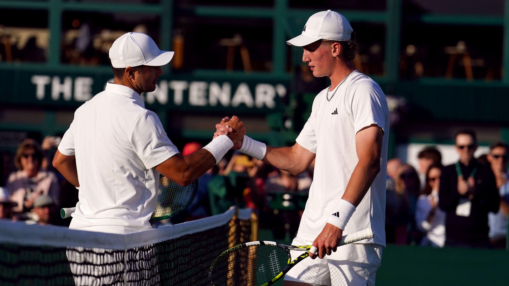 Henry Searle (right) and Marcos Giron shake hands at Wimbledon