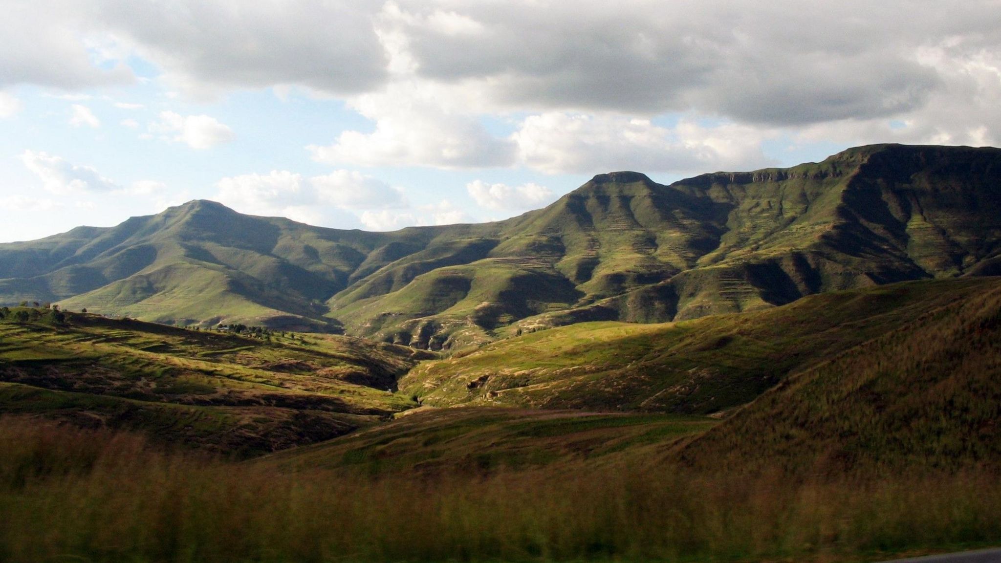 African highlands which are covered in greenery. Below is a dry valley.