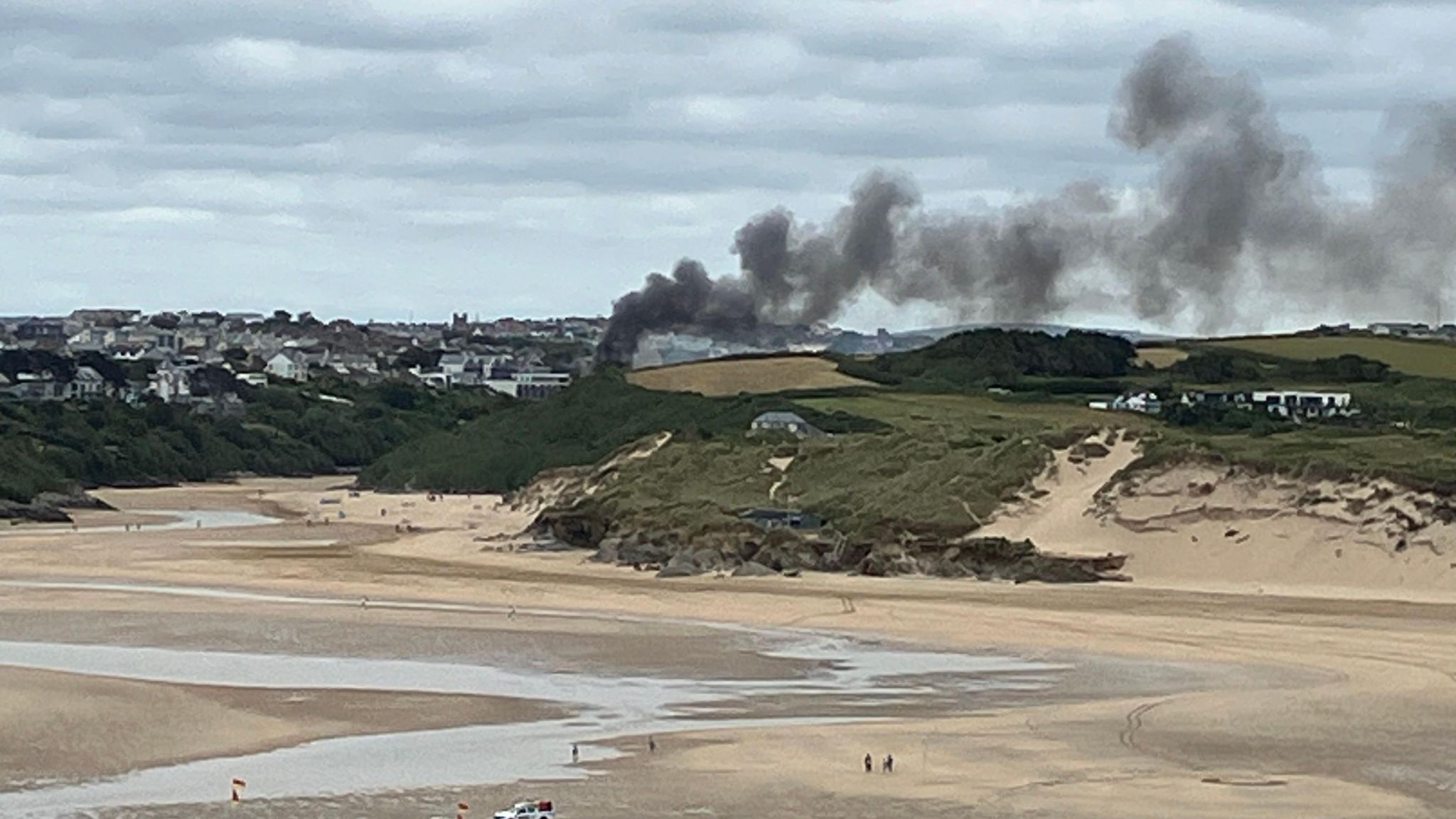 Smoke rising above Pentire photographed from the opposite side of the point