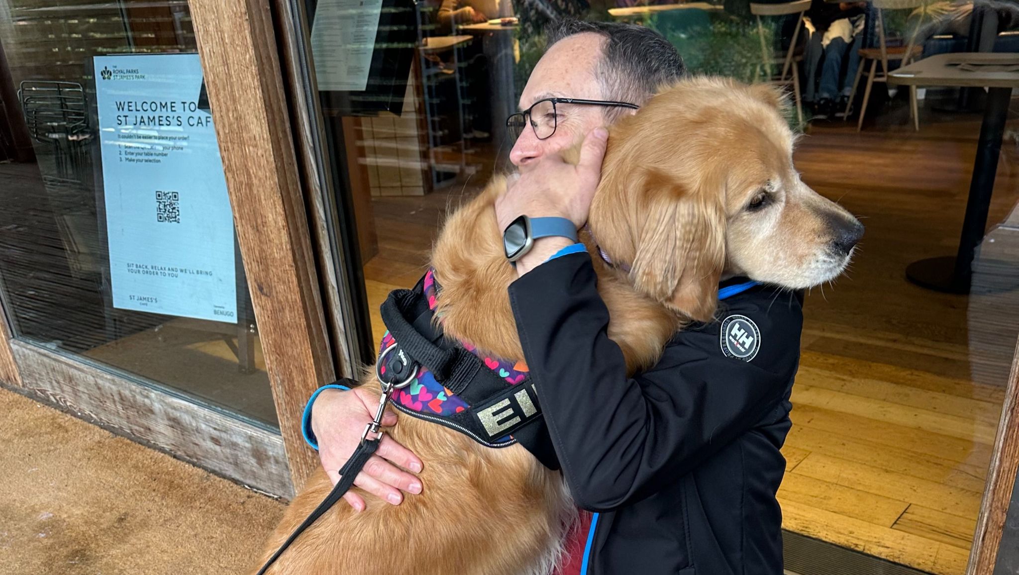 Mark hugging the golden retriever, Ellie